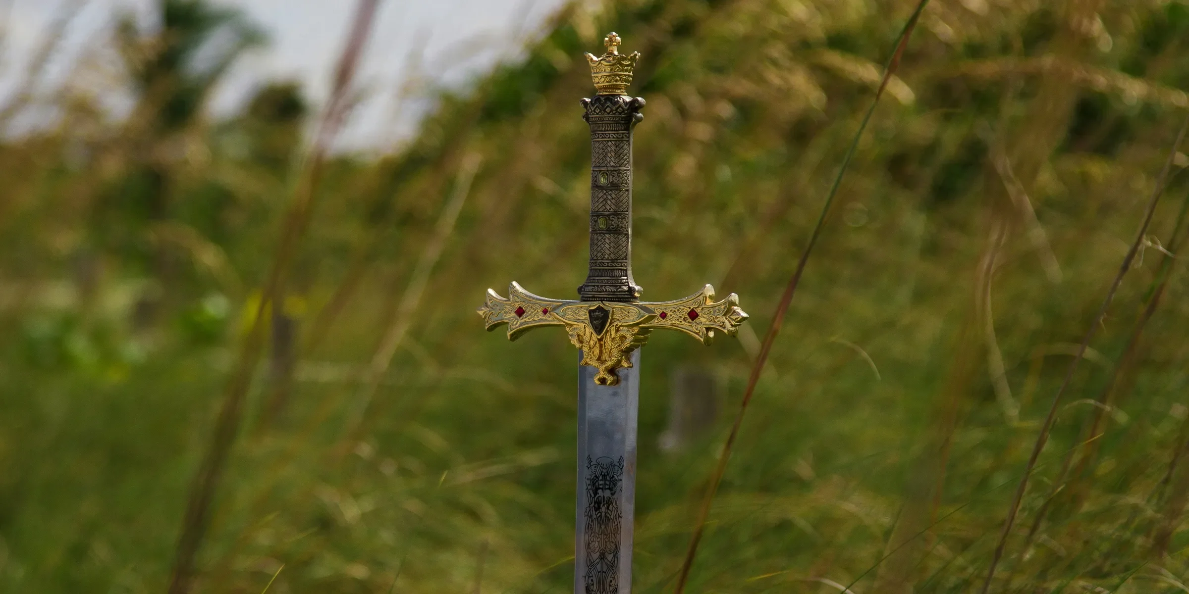 gray steel sword on ground during daytime