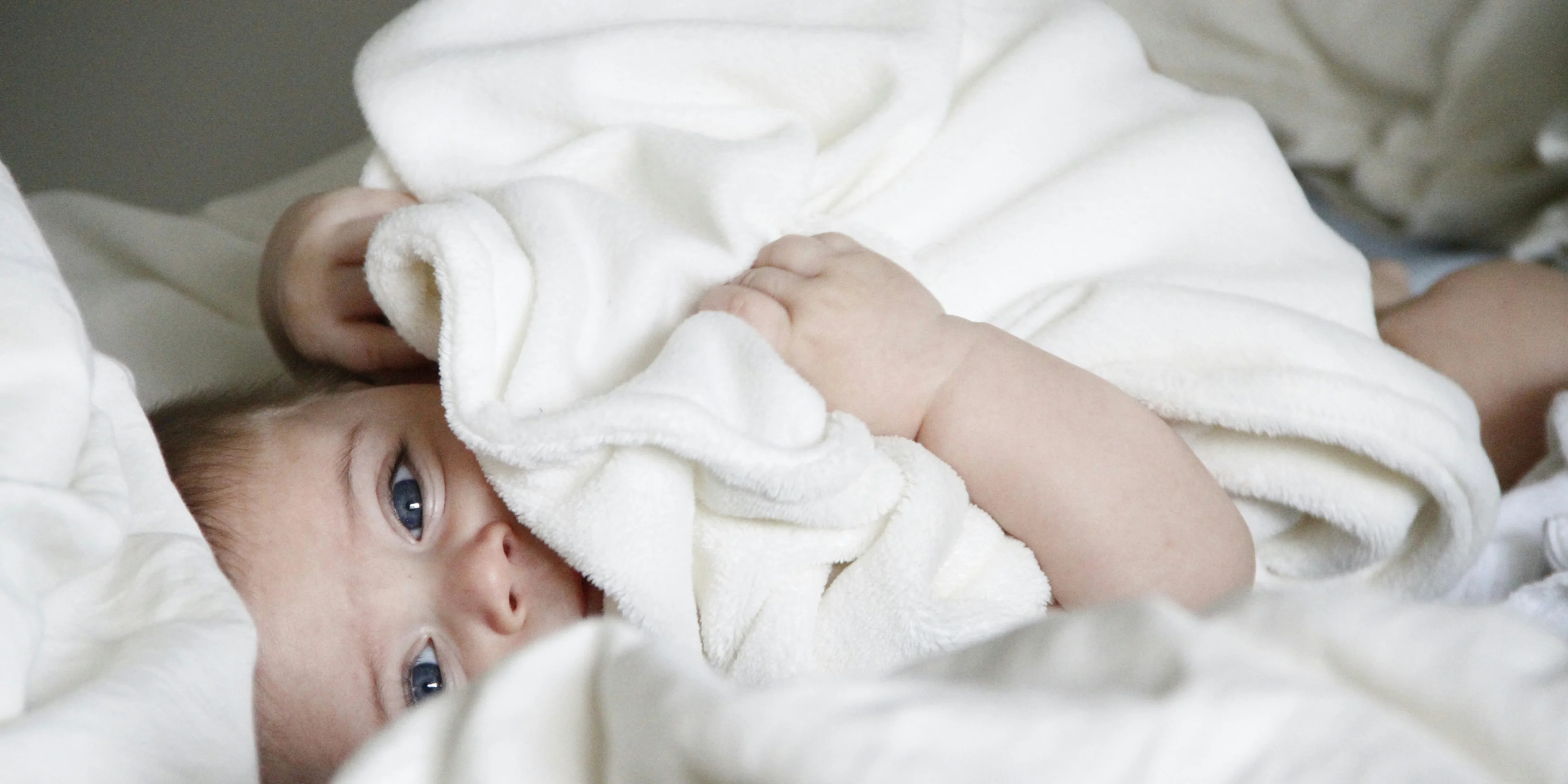 baby laying on bed.