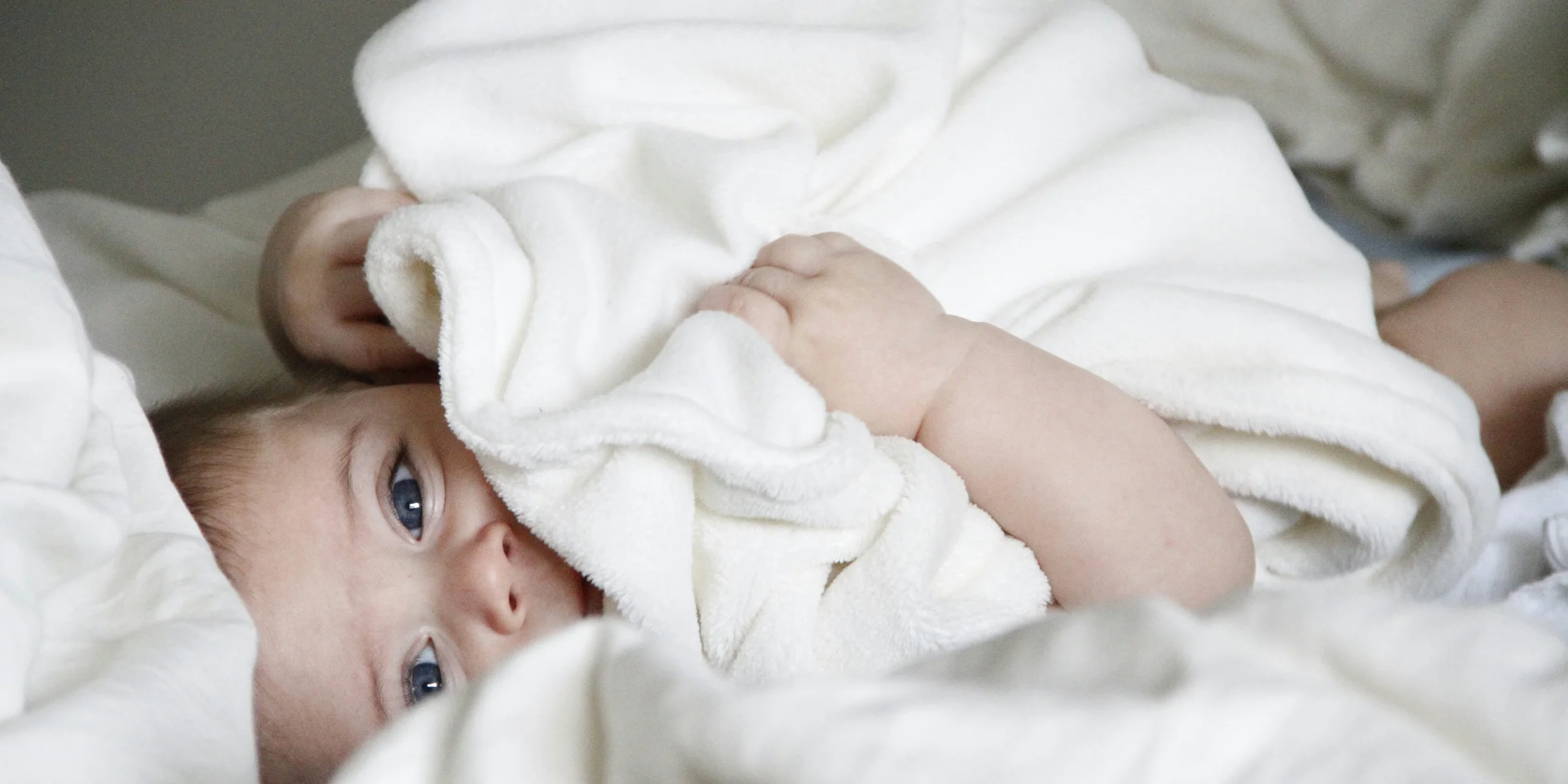 baby laying on bed.