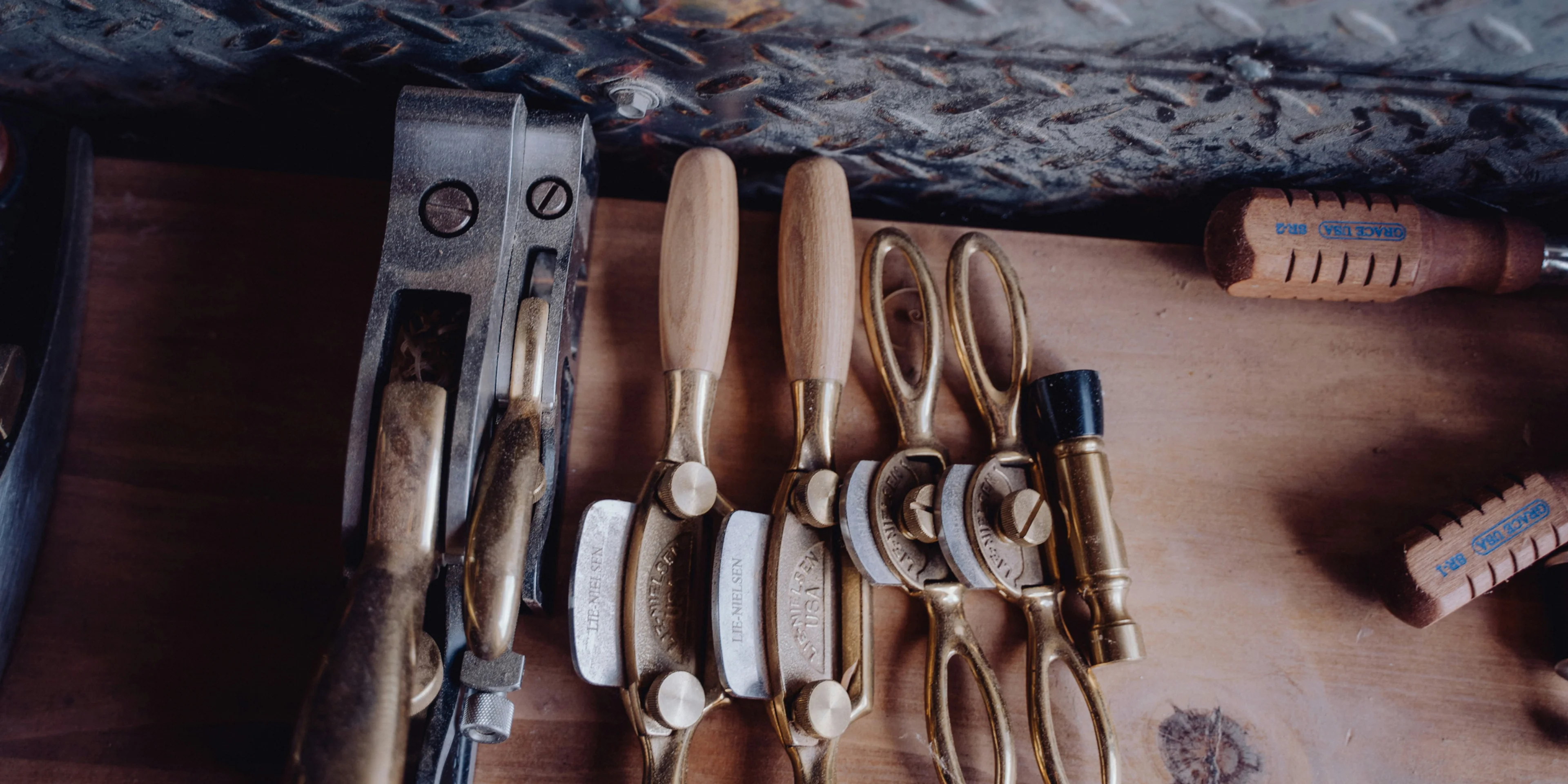a wooden table topped with lots of different types of tools