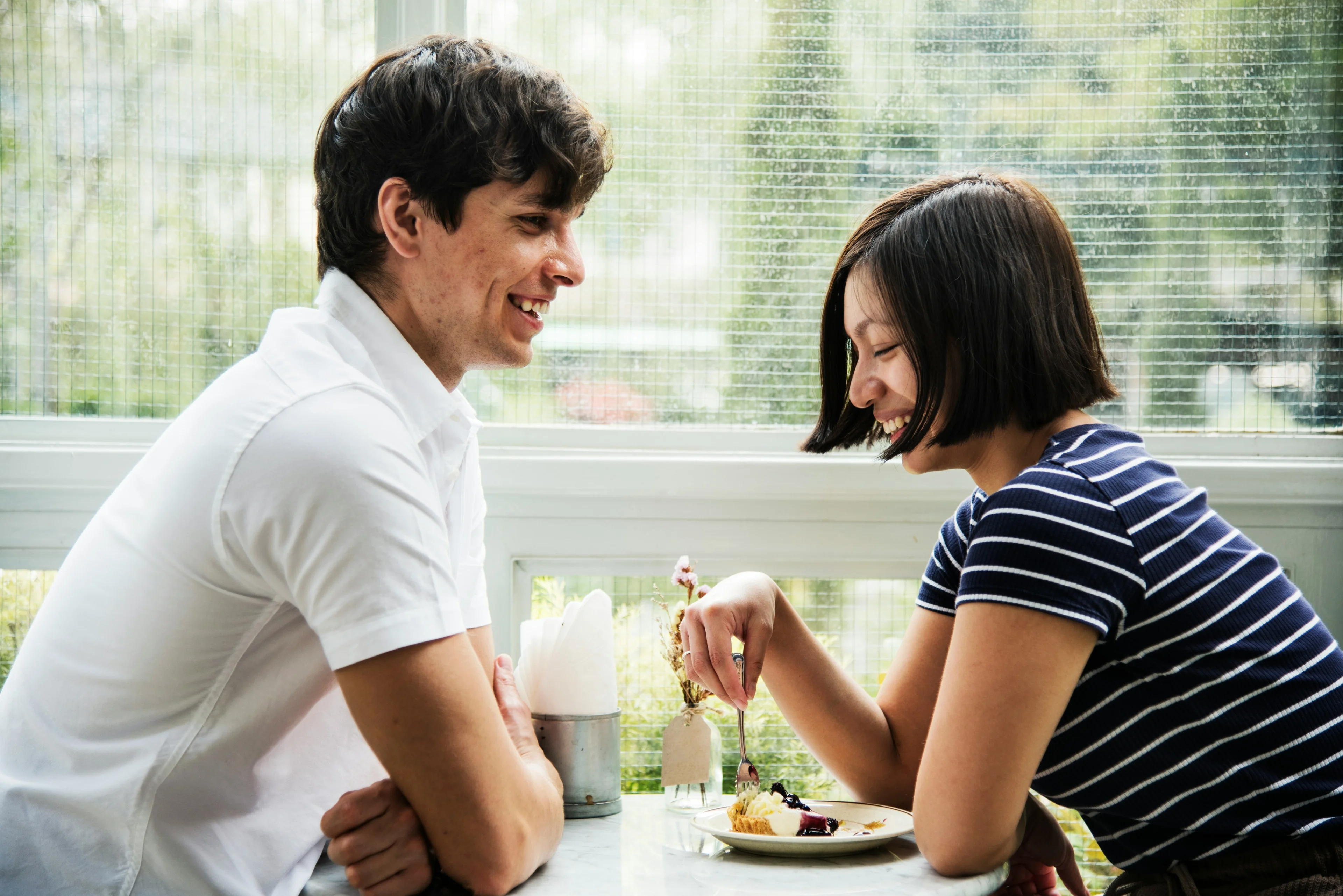 a couple eating a cake