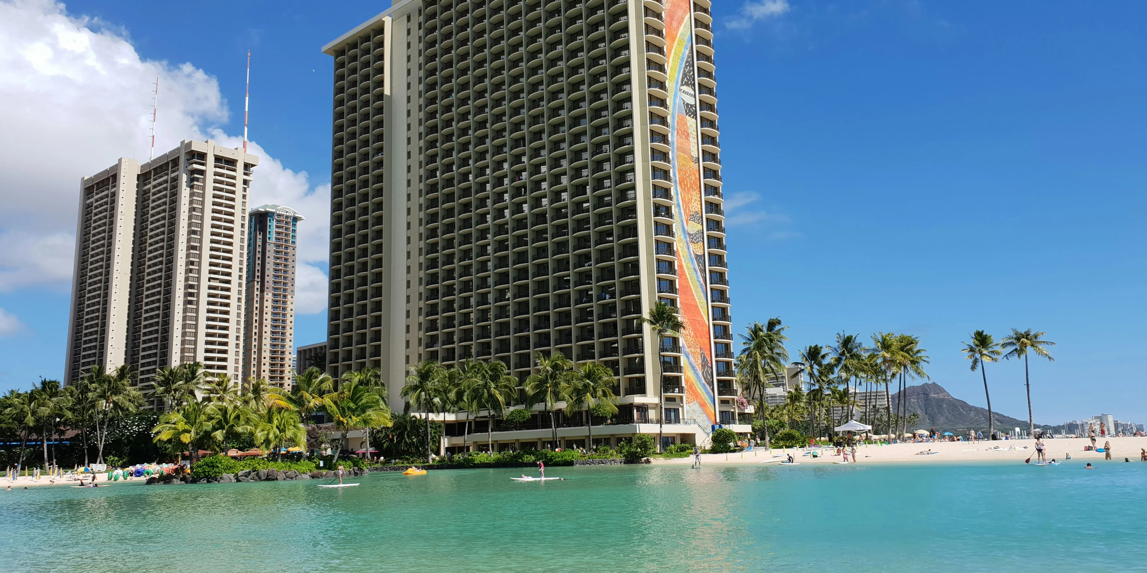 white and brown high rise building near body of water during daytime.
