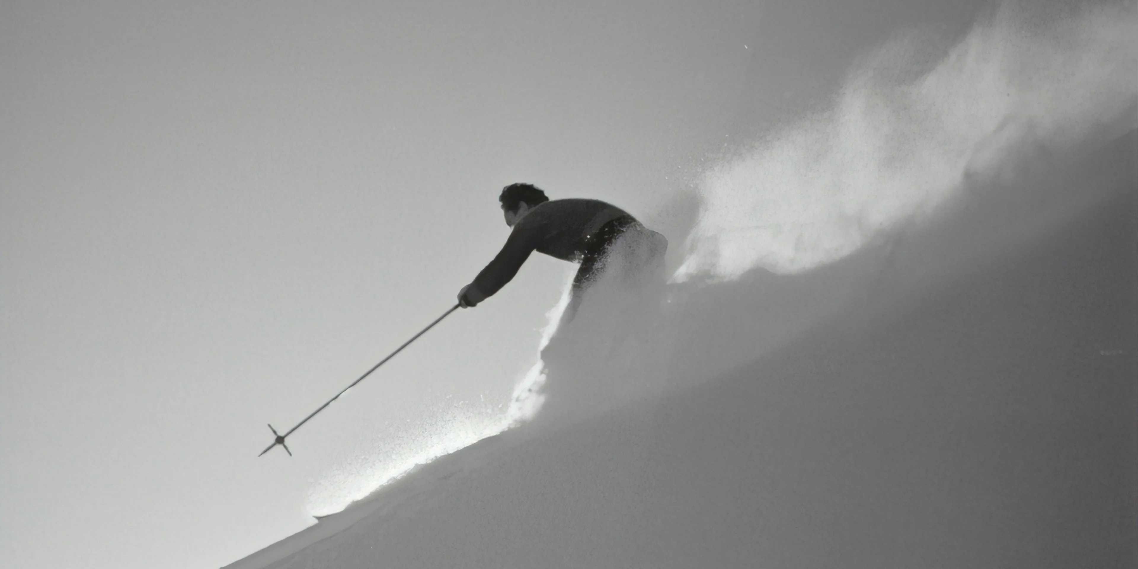grayscale photography of man skiing on snow