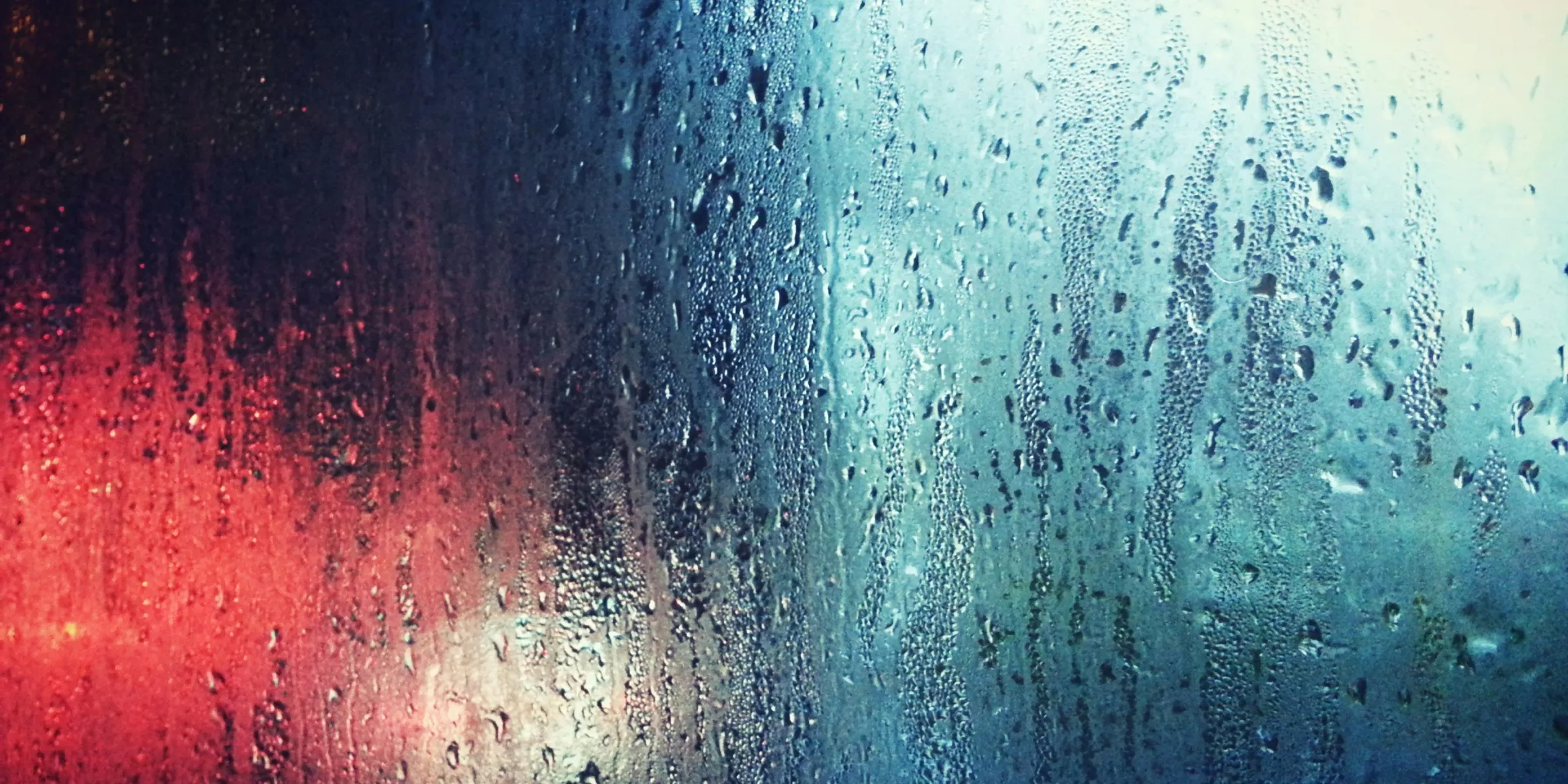 a close up of a window with rain drops