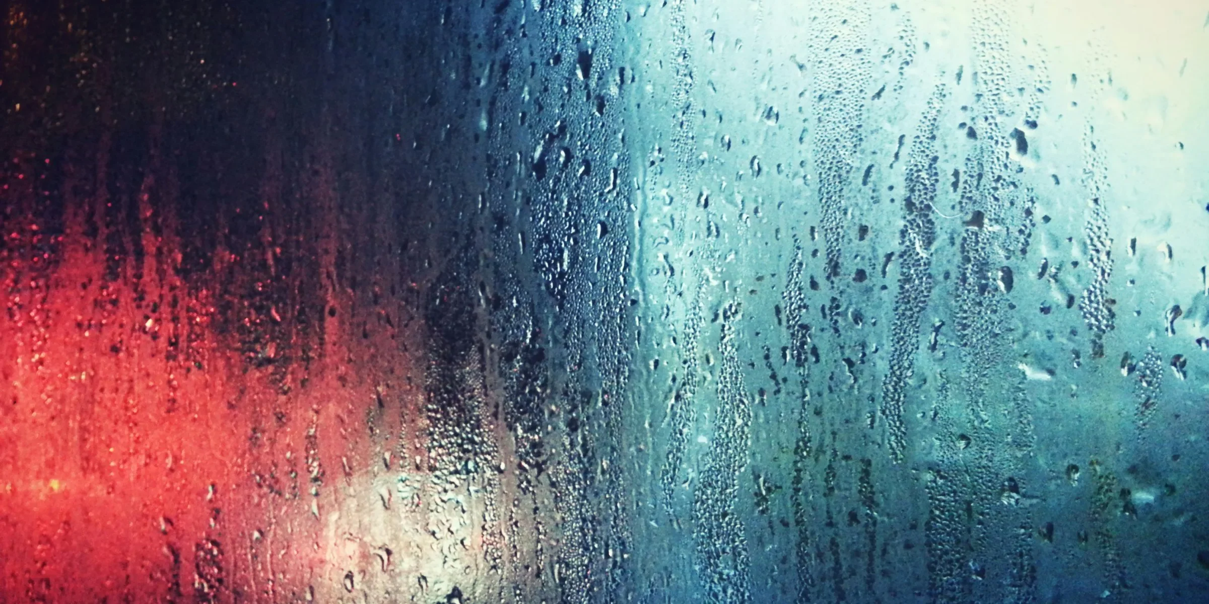 a close up of a window with rain drops