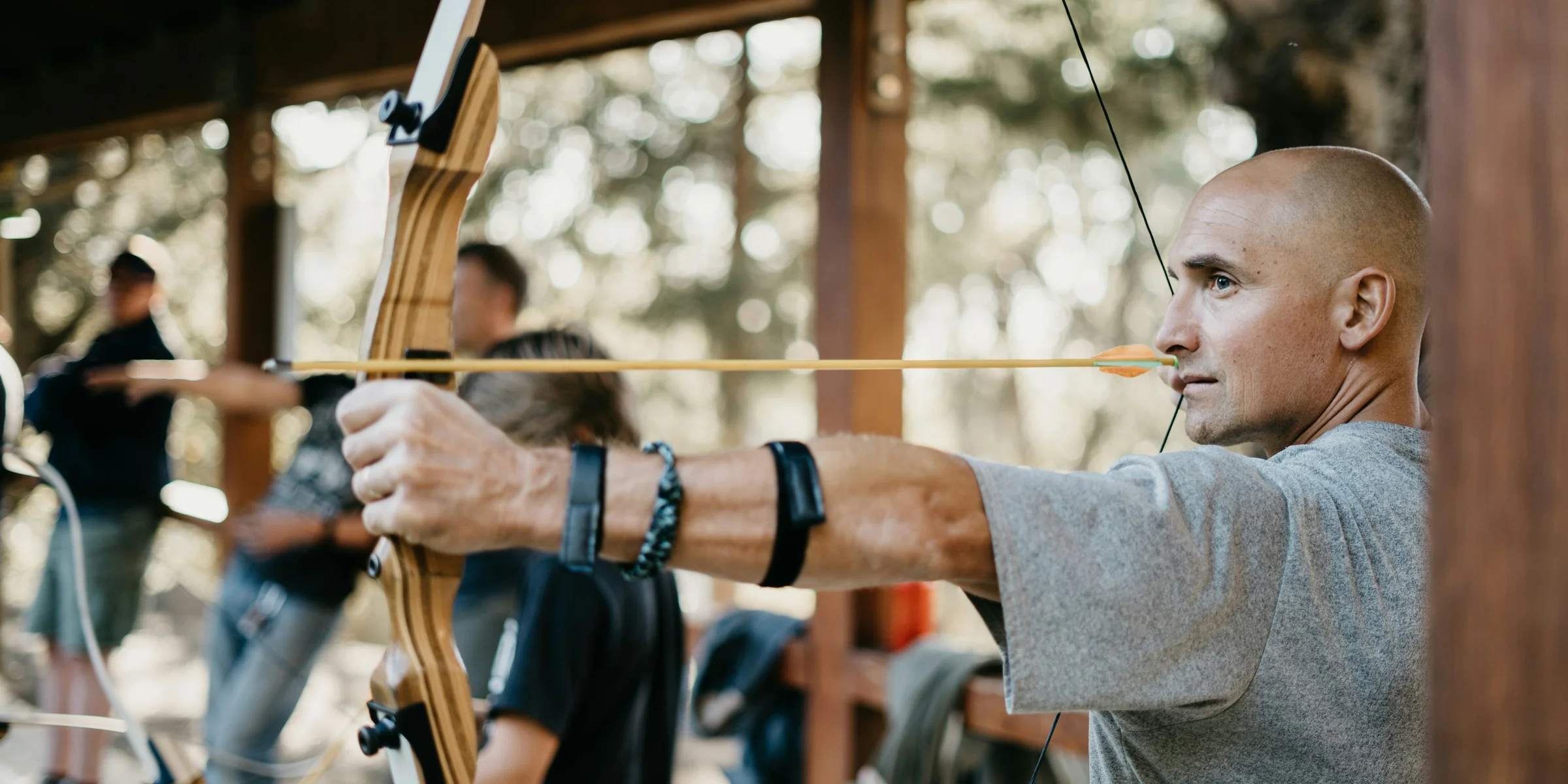 man using a brown bow