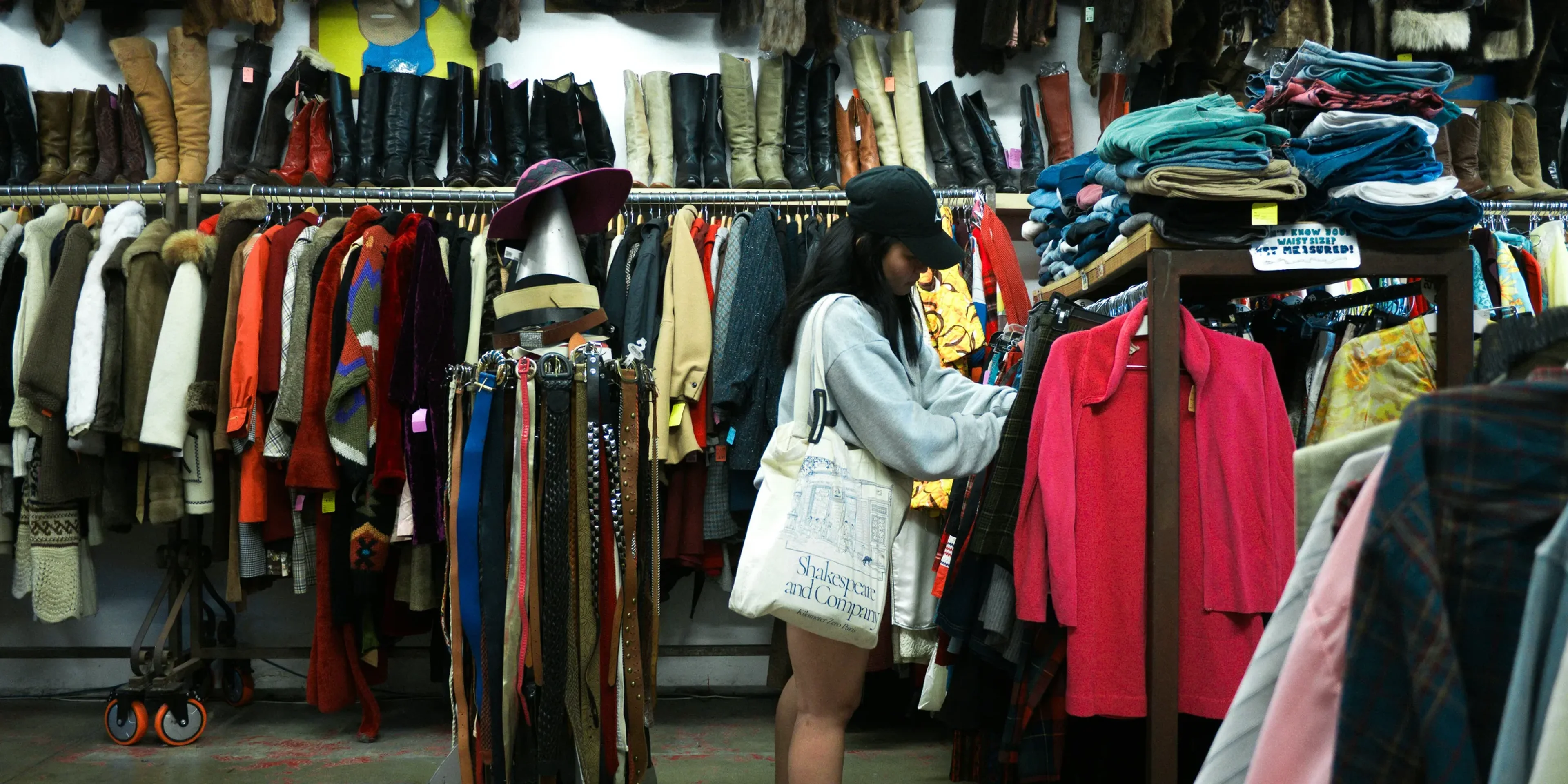 Woman browsing clothes at a thrift store.