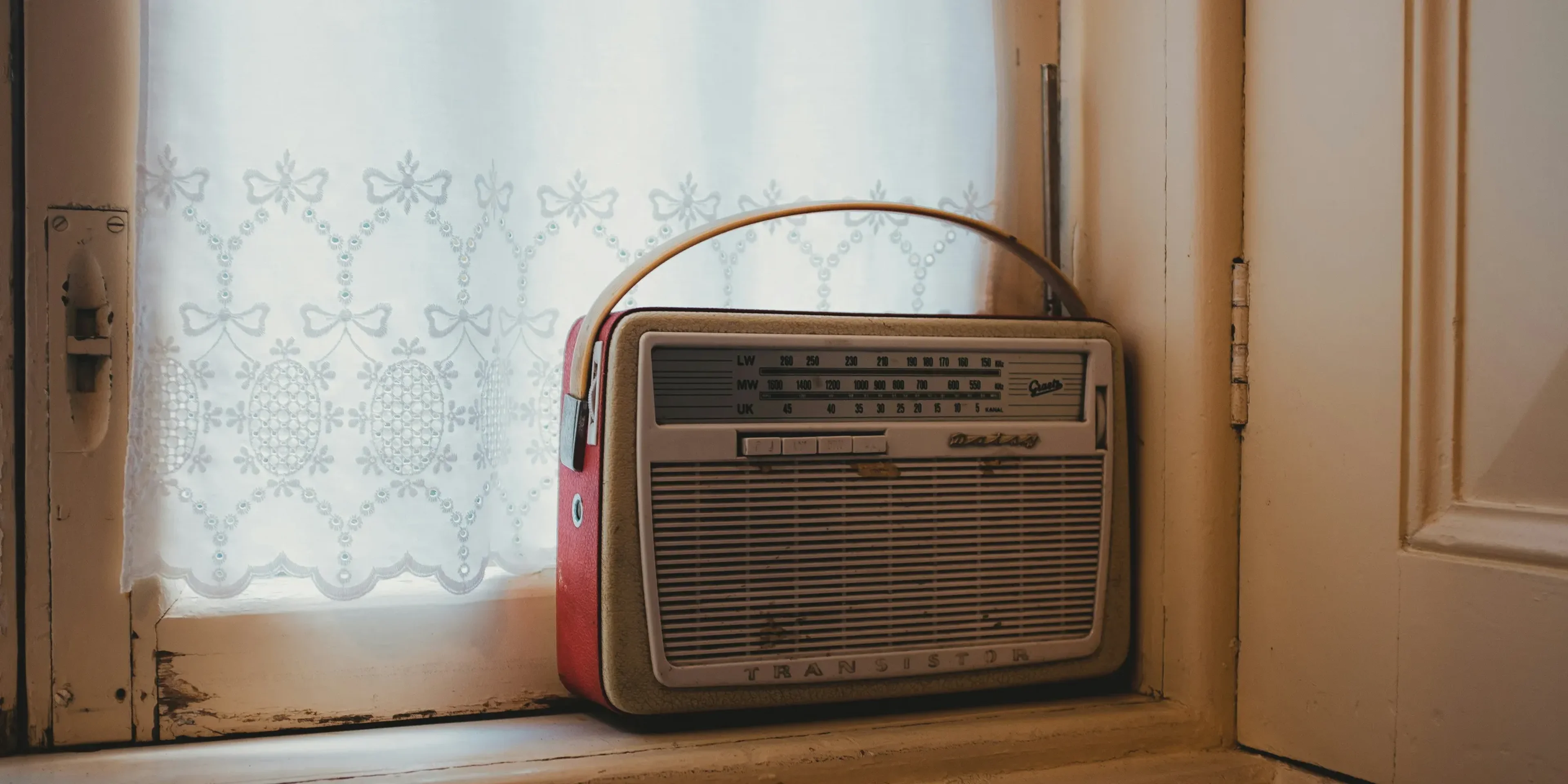 a radio sitting on top of a window sill