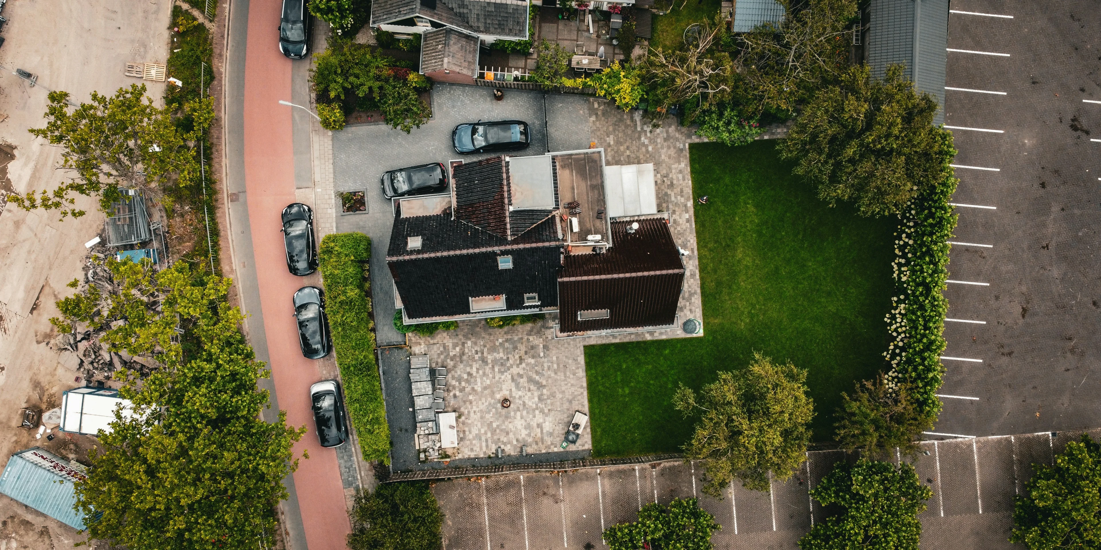 a building with a lawn and cars.