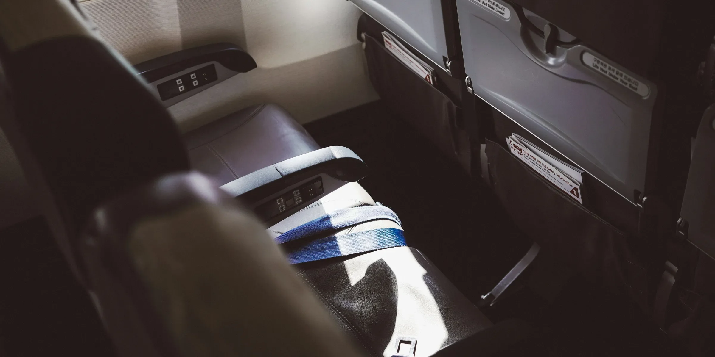 person in blue white and black shorts sitting on car seat