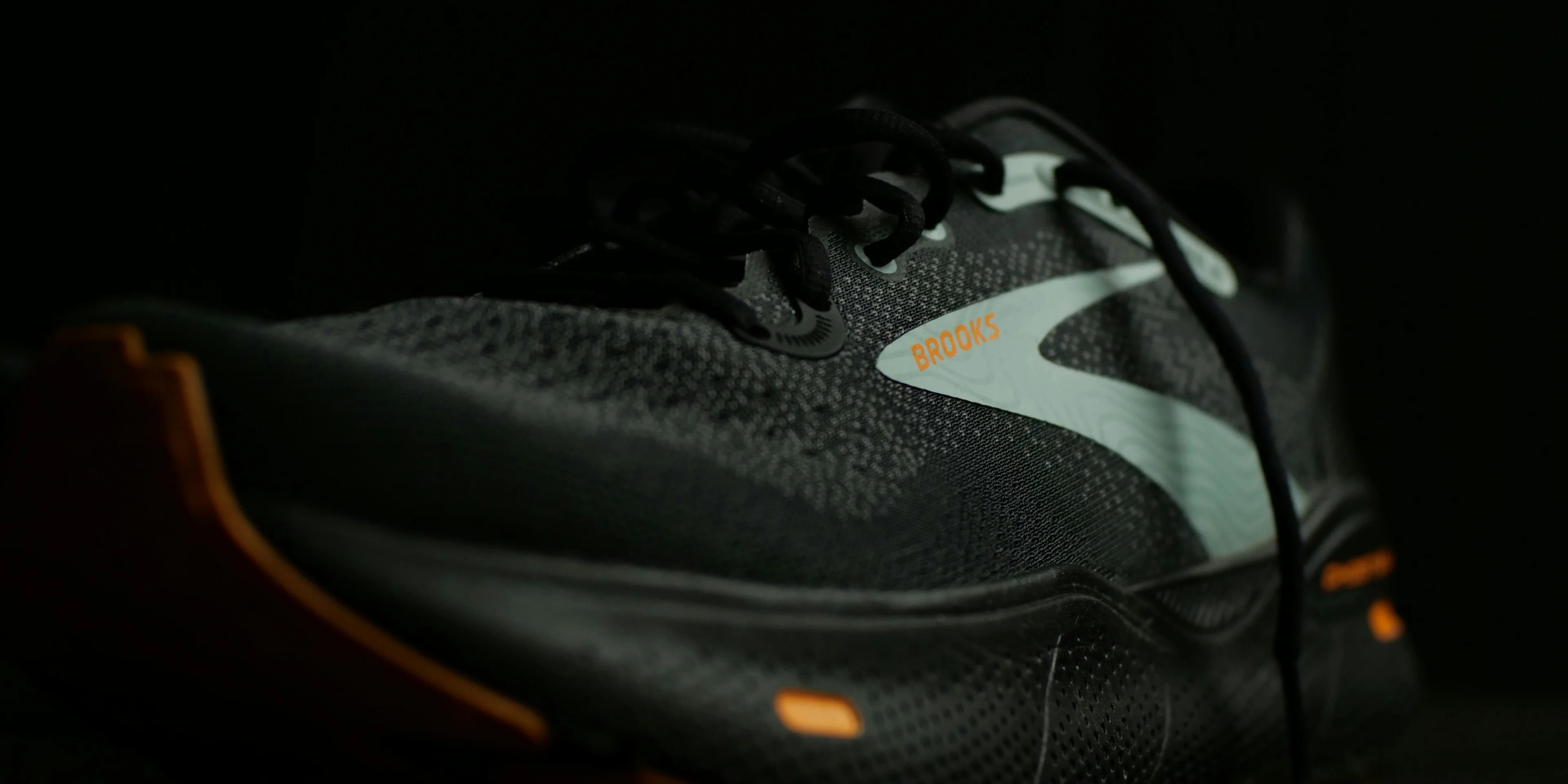 a pair of black and orange running shoes