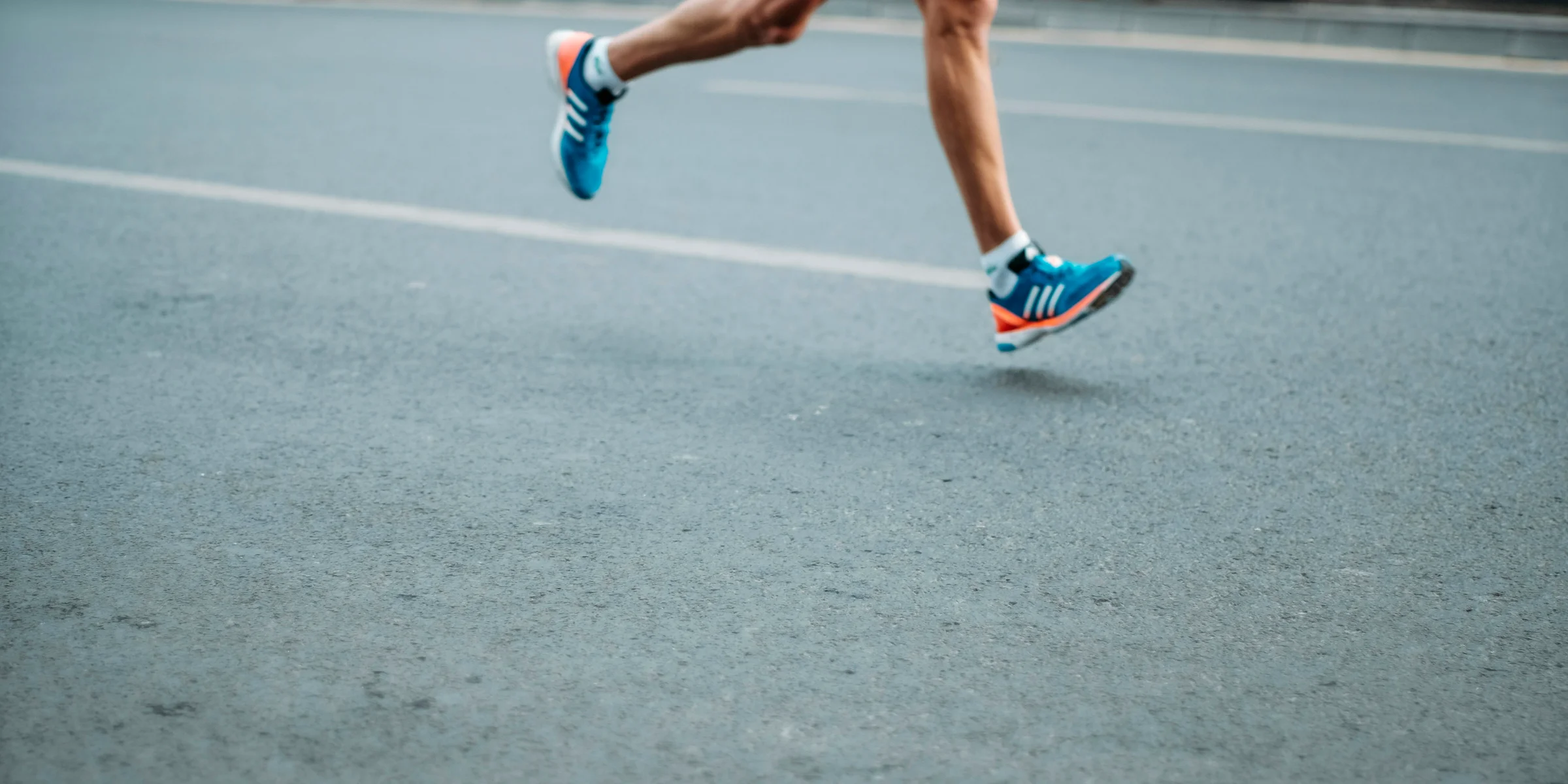 pair of blue-and-white Adidas running shoes.