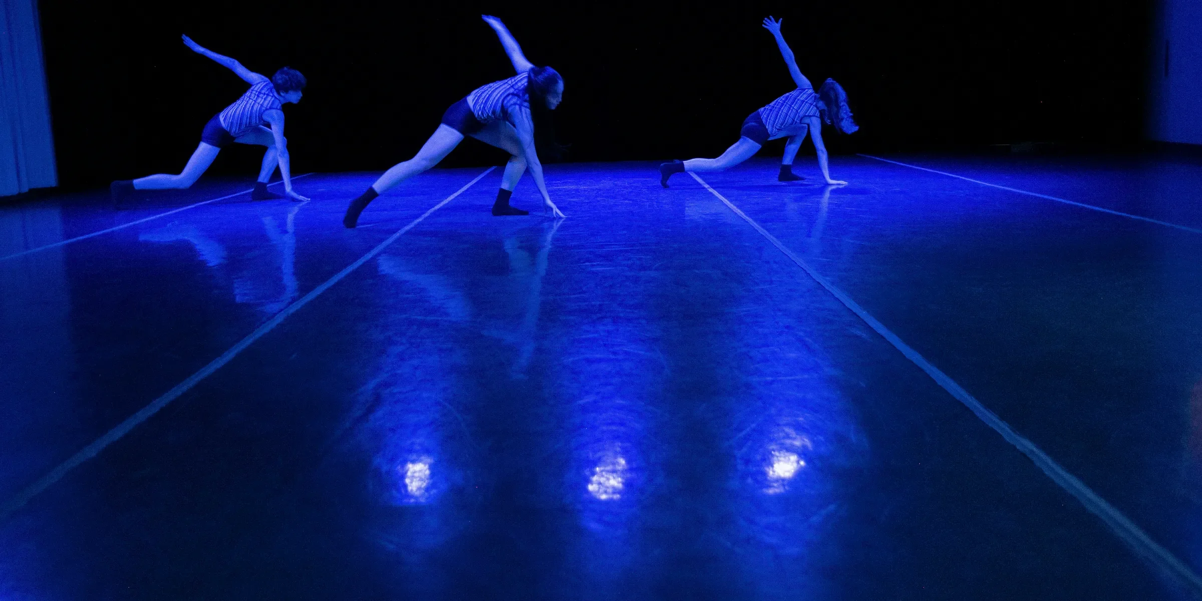 a group of dancers performing on a stage