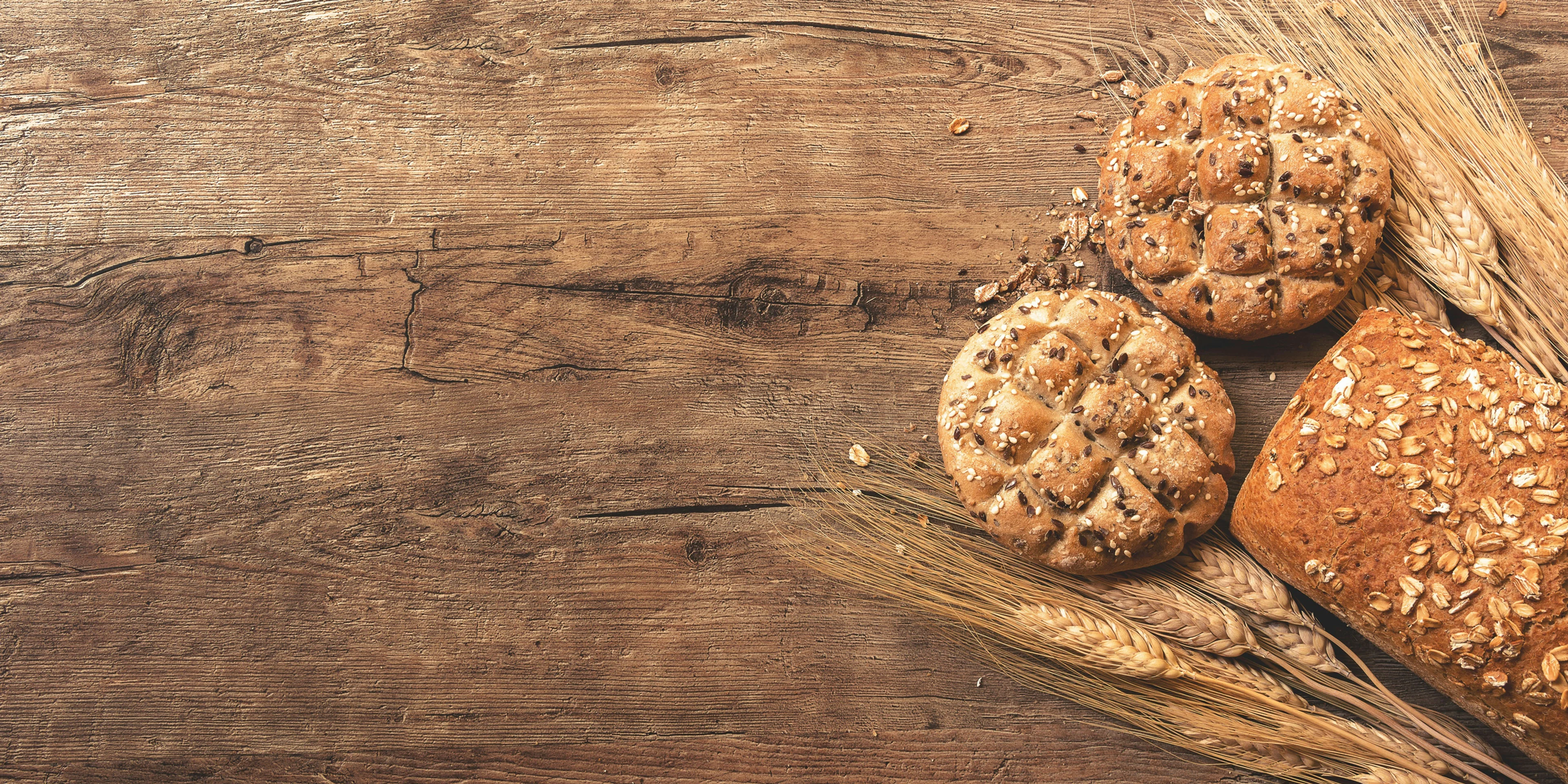 cookies, bread, and wheat on table.