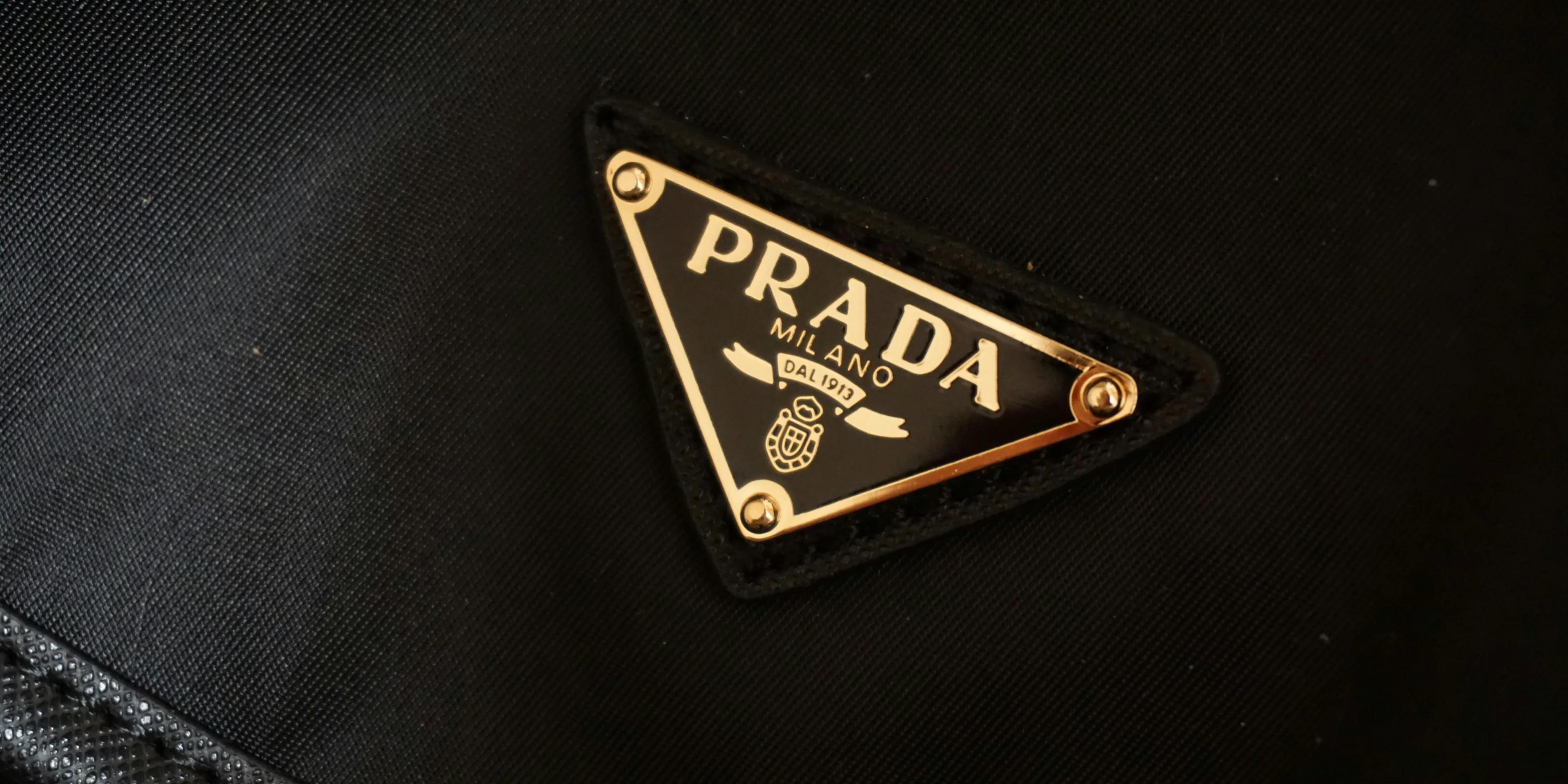 a prada logo on a black jacket.