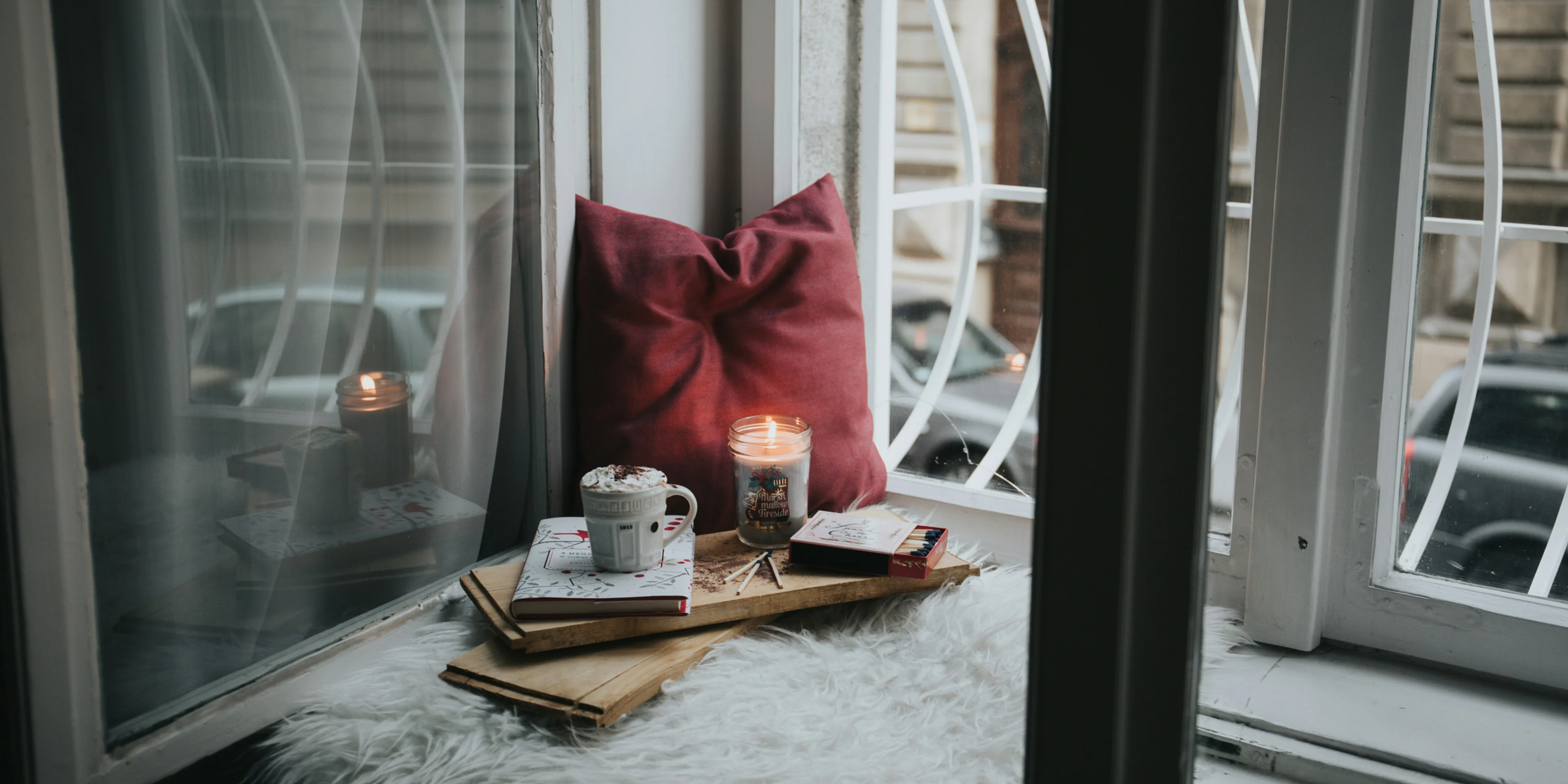 photo of gel candle on board beside pillow.