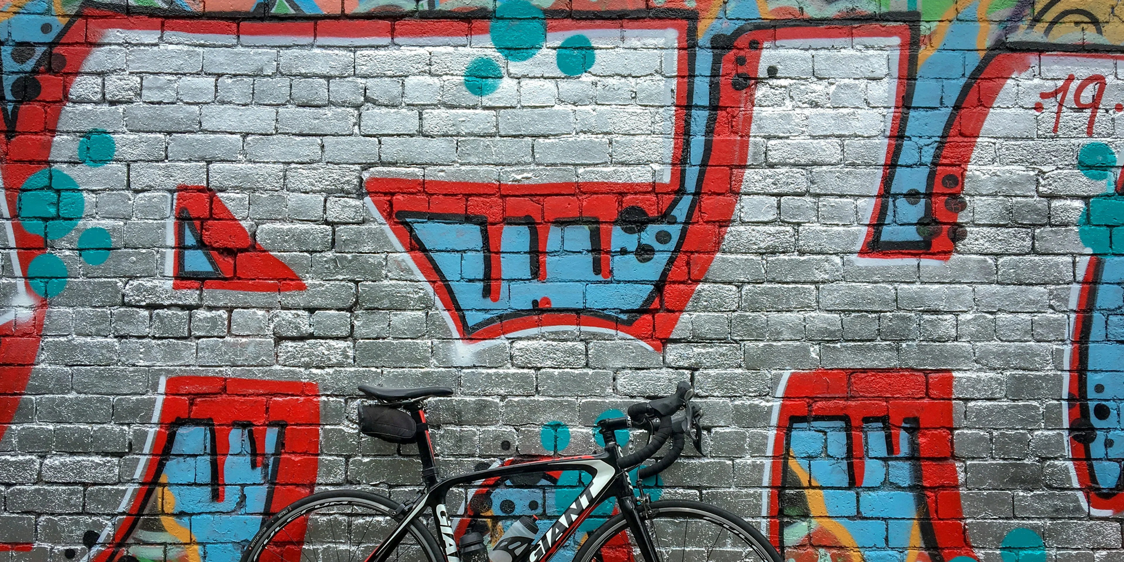 black road bike near wall.