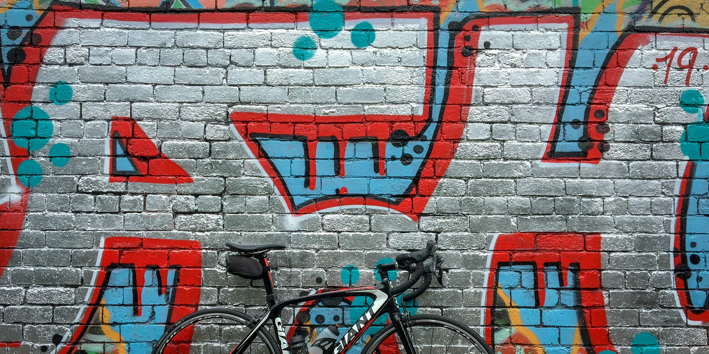 black road bike near wall.