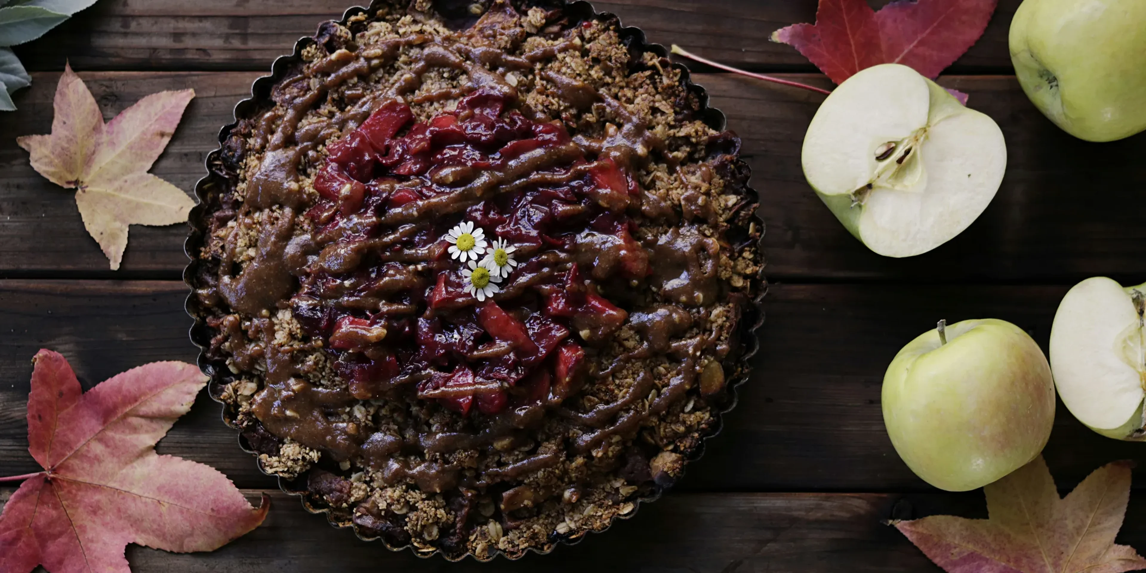 baked pastry on brown wooden surface beside sliced apples