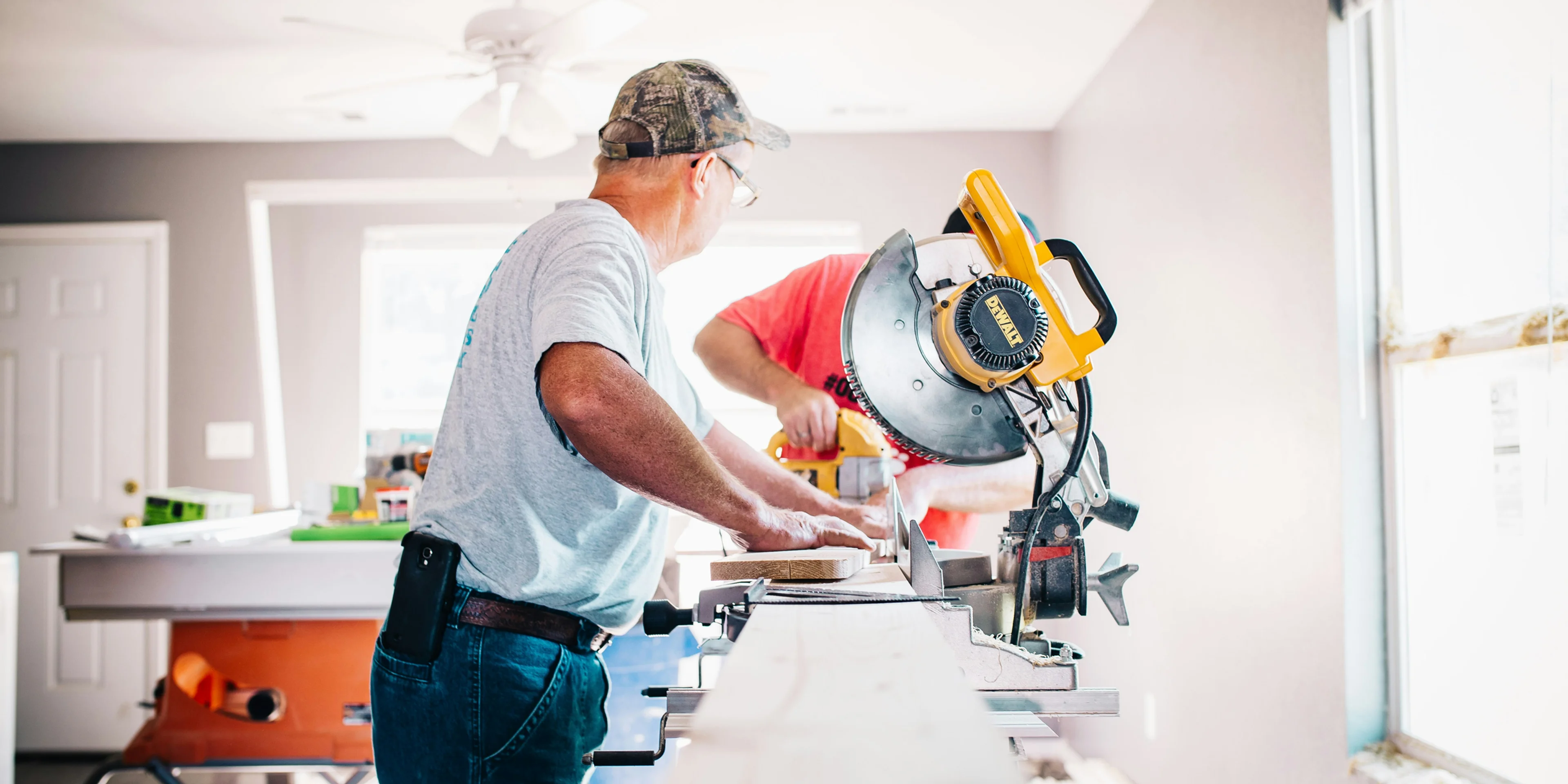 man standing infront of miter saw.