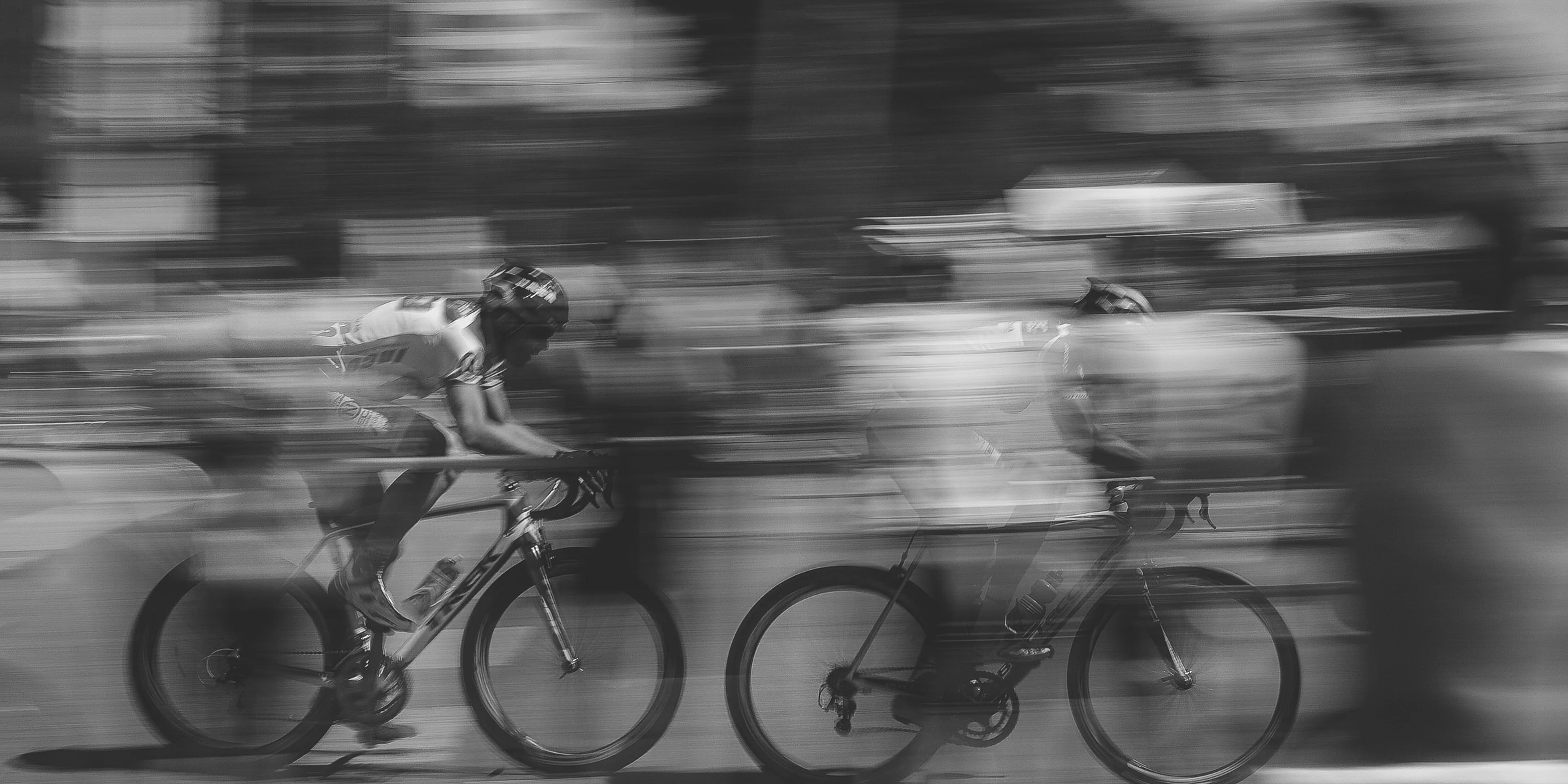 two persons riding on bicycles.