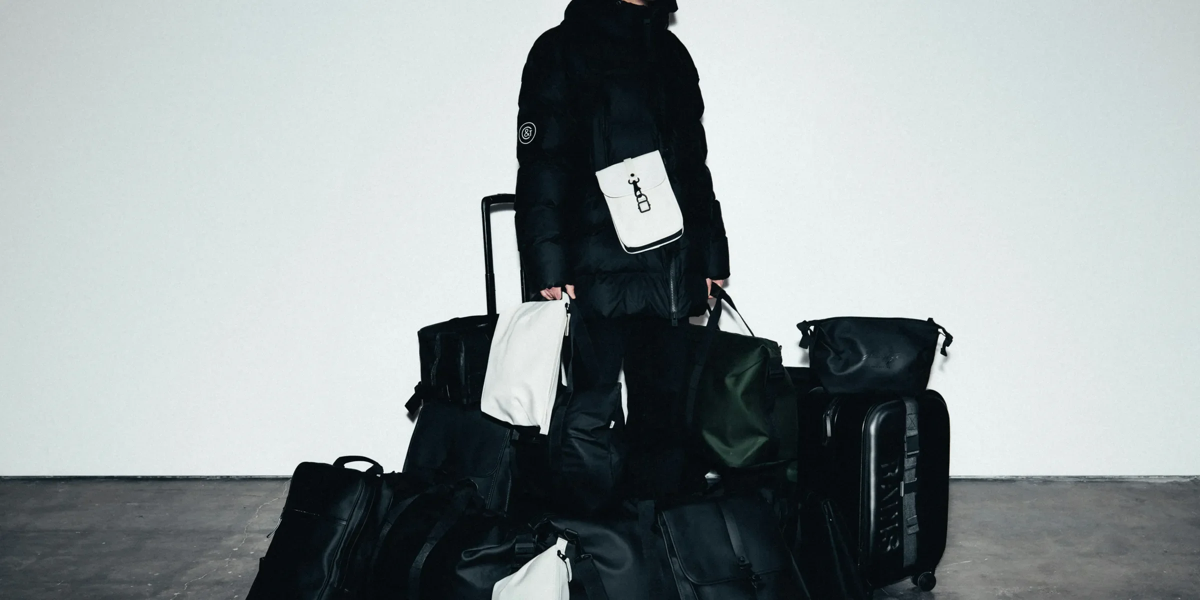 Man in winter coat surrounded by luggage
