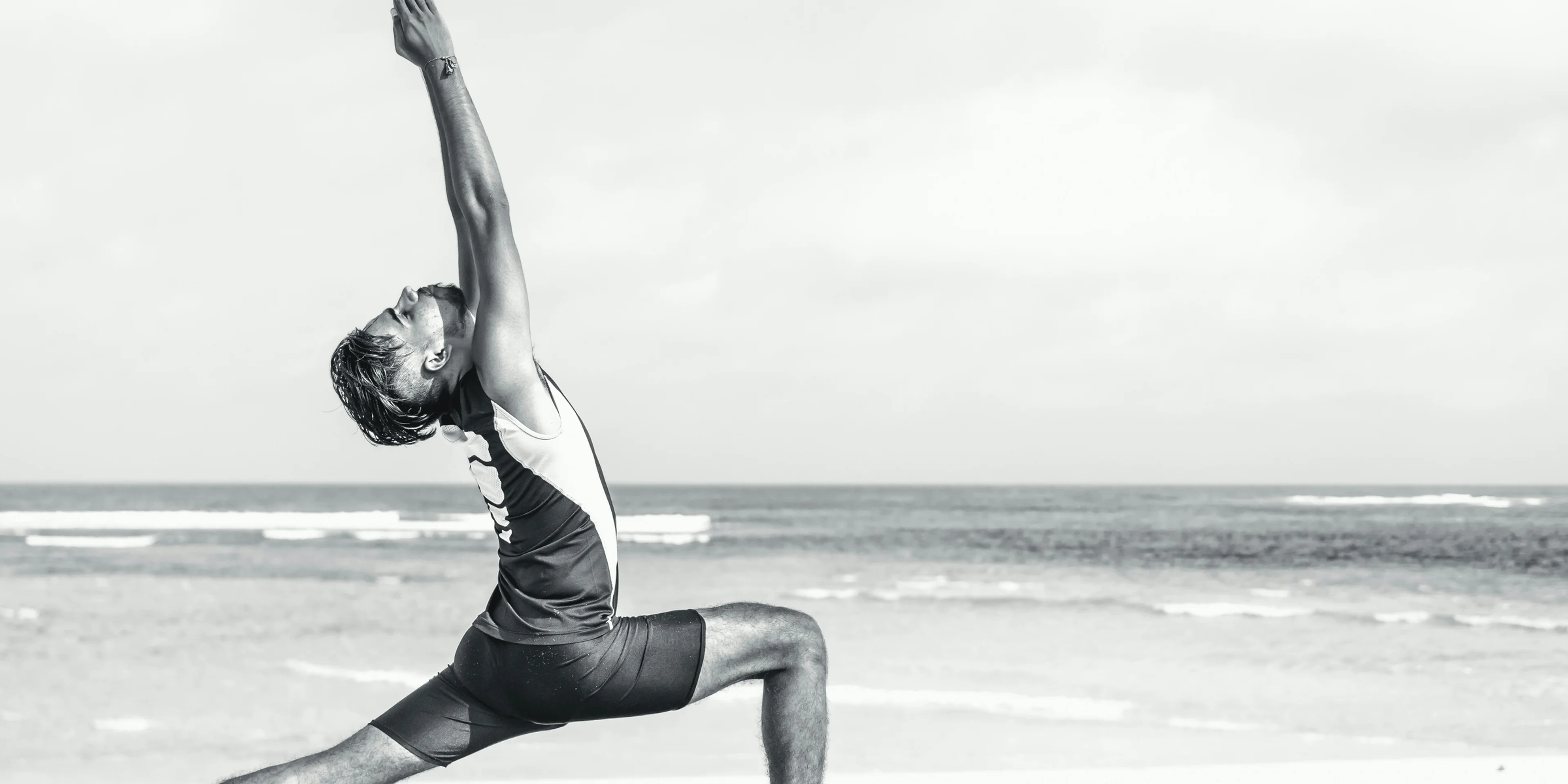 man stretching on seashore.