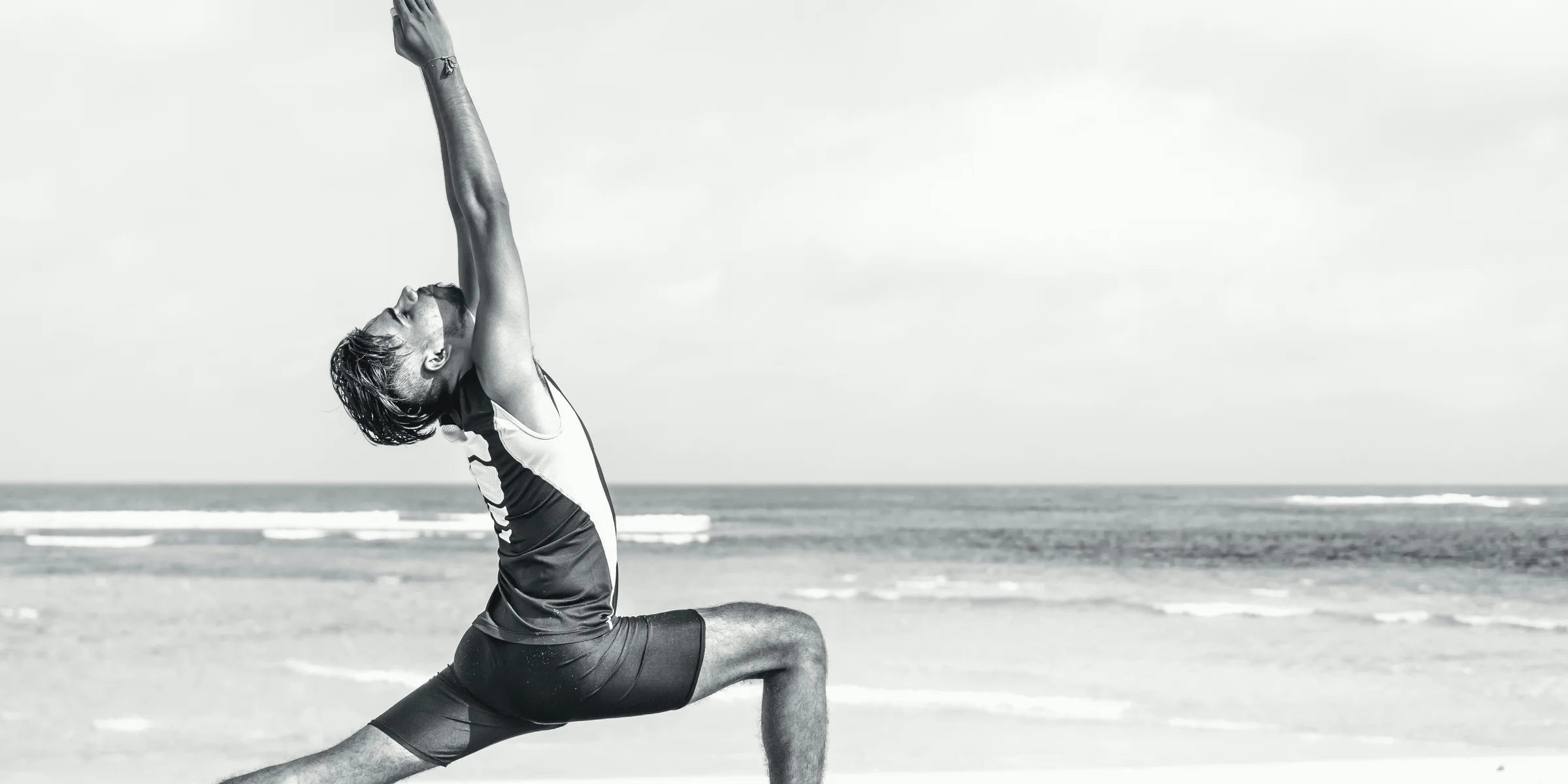 man stretching on seashore.