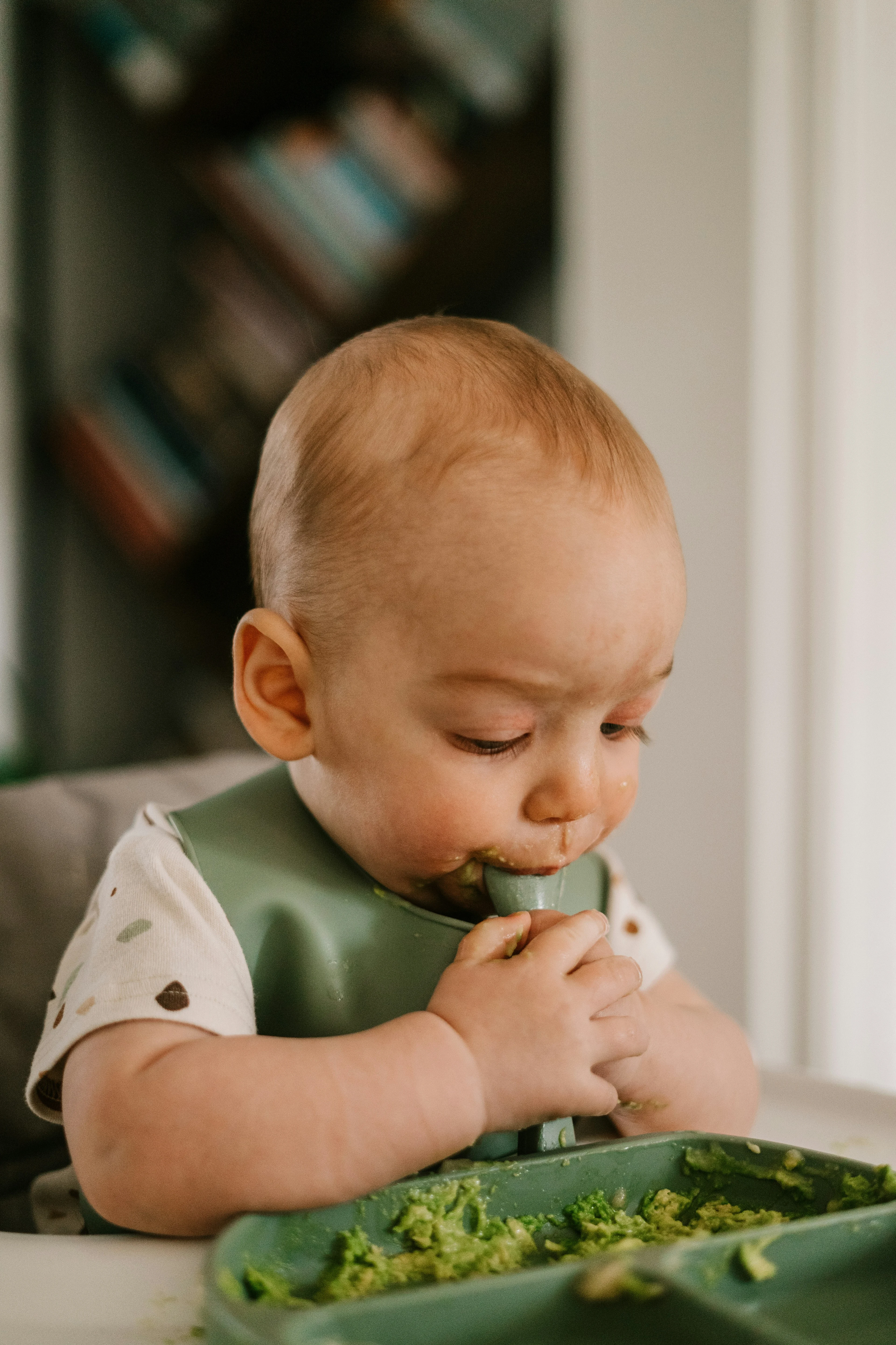 baby eating with bib