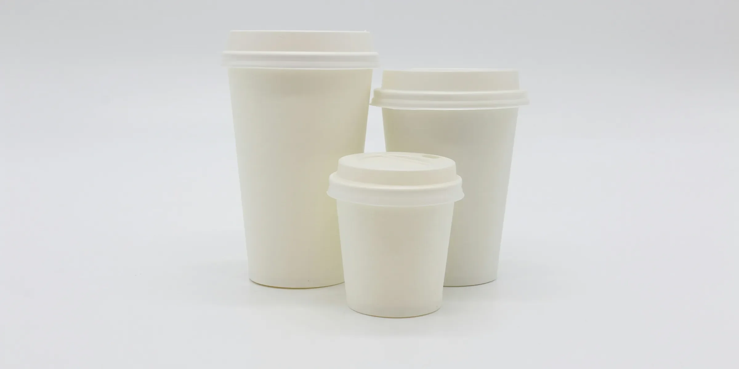 three white disposable cups