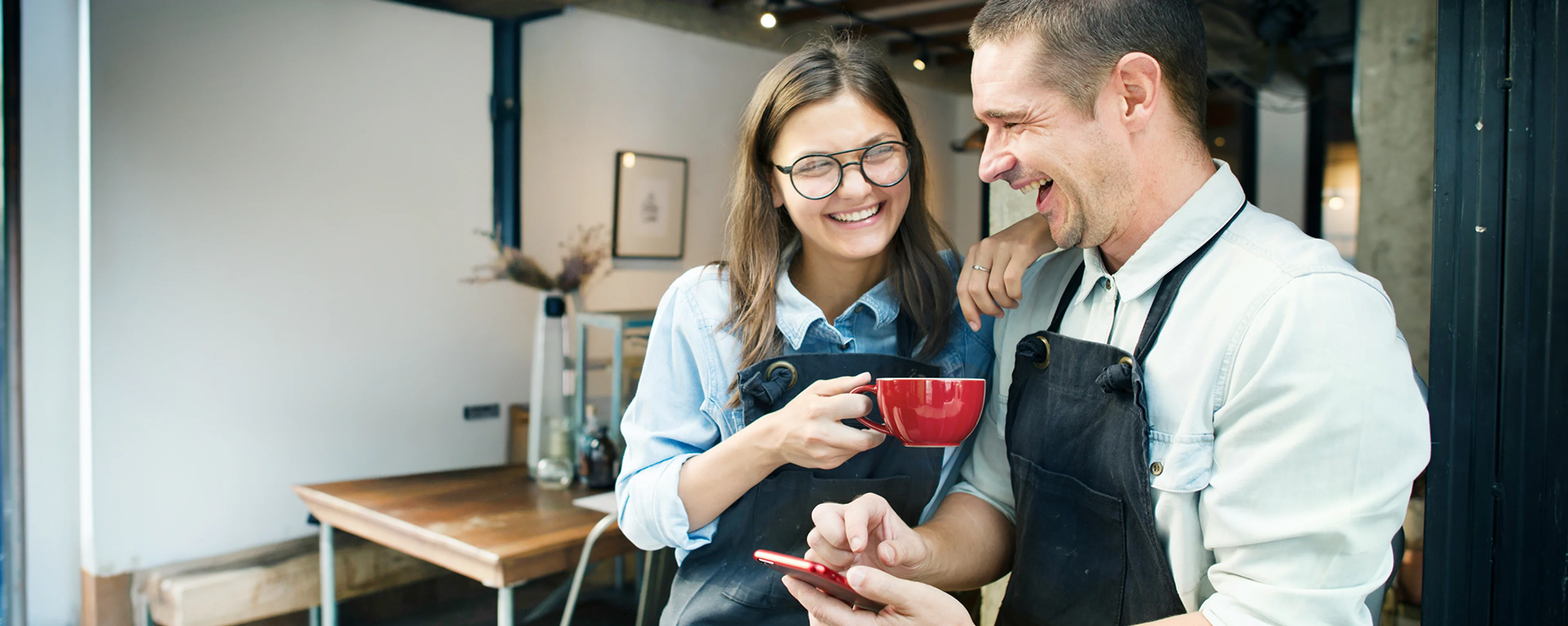two baristas smiling
