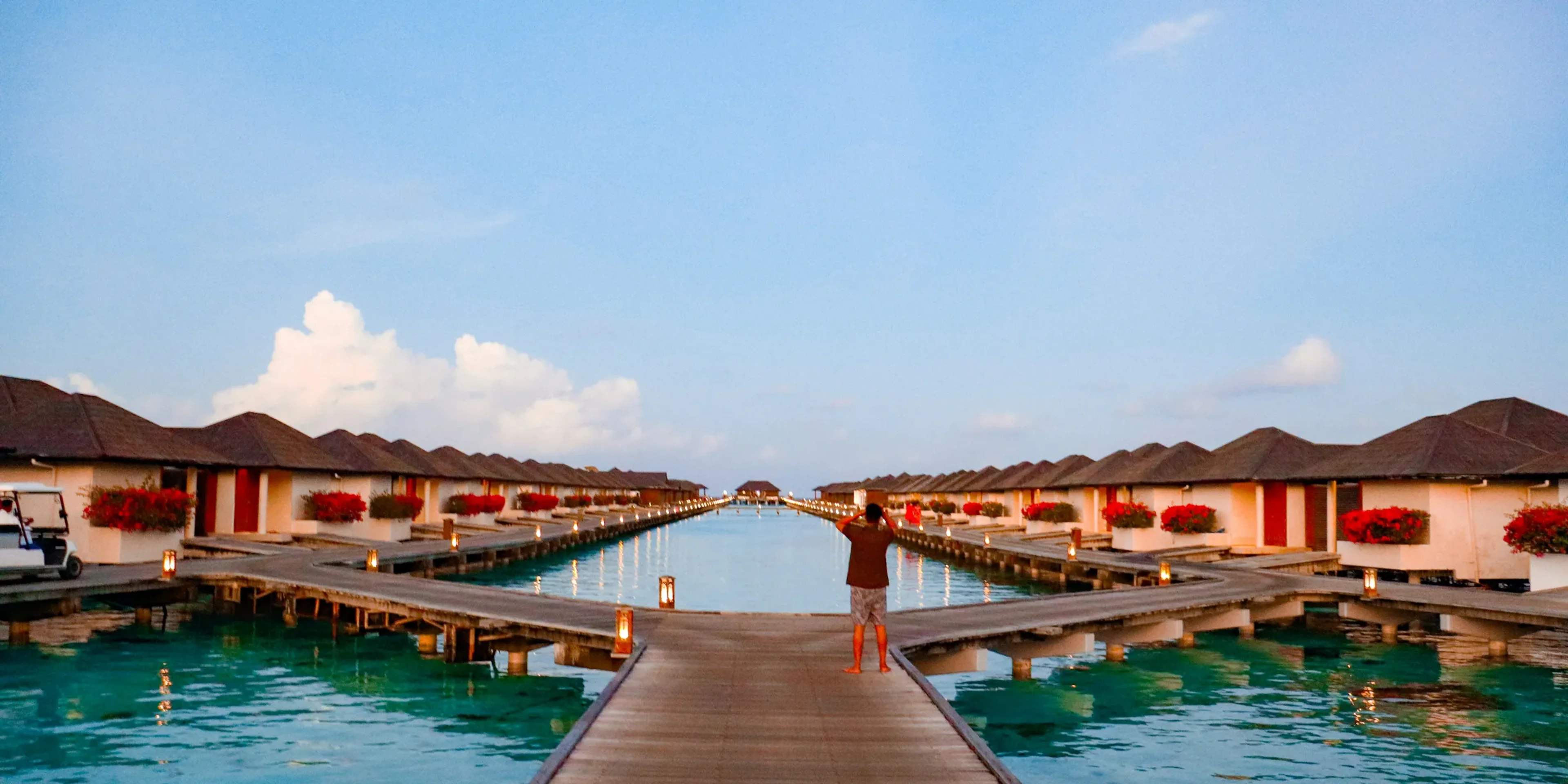 Overwater bungalows line a beautiful, turquoise sea.