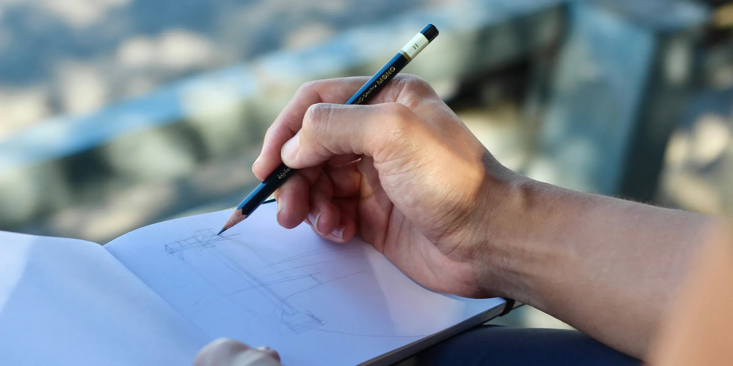 person sketching on white pad