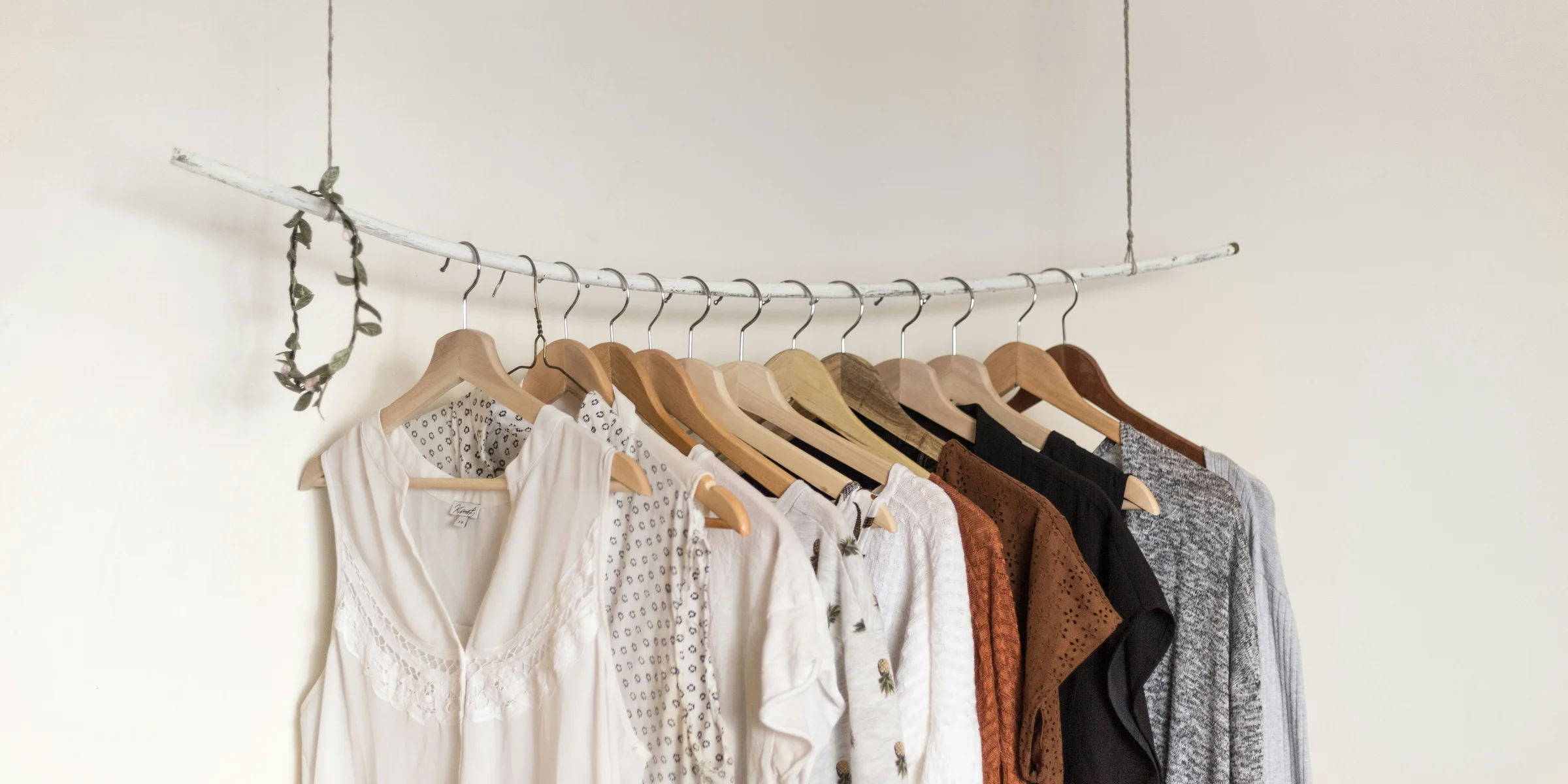 assorted clothes in wooden hangers.