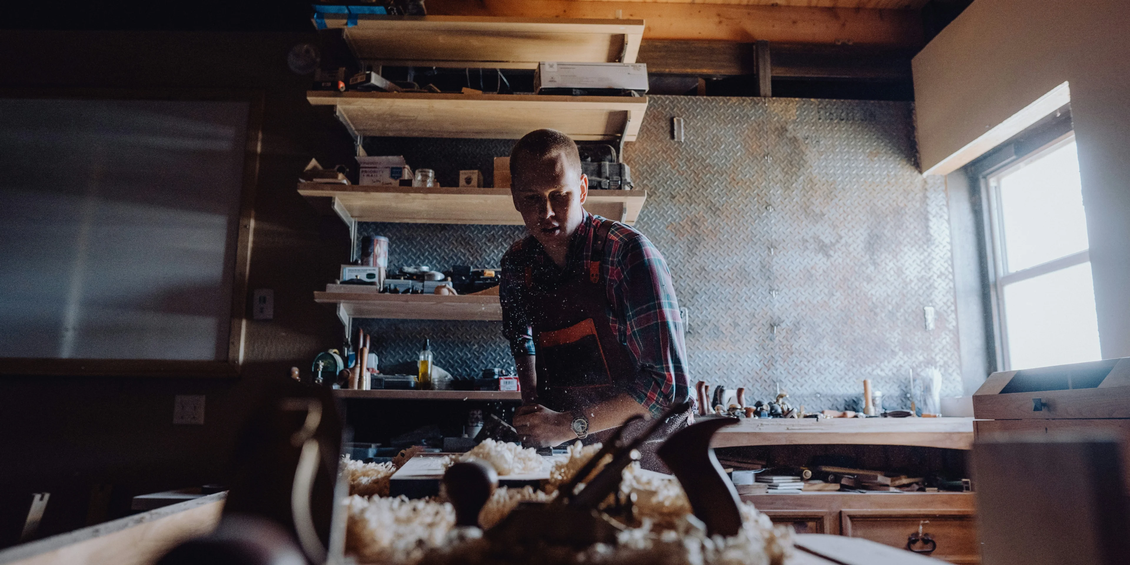 a man working in a woodworking shop.