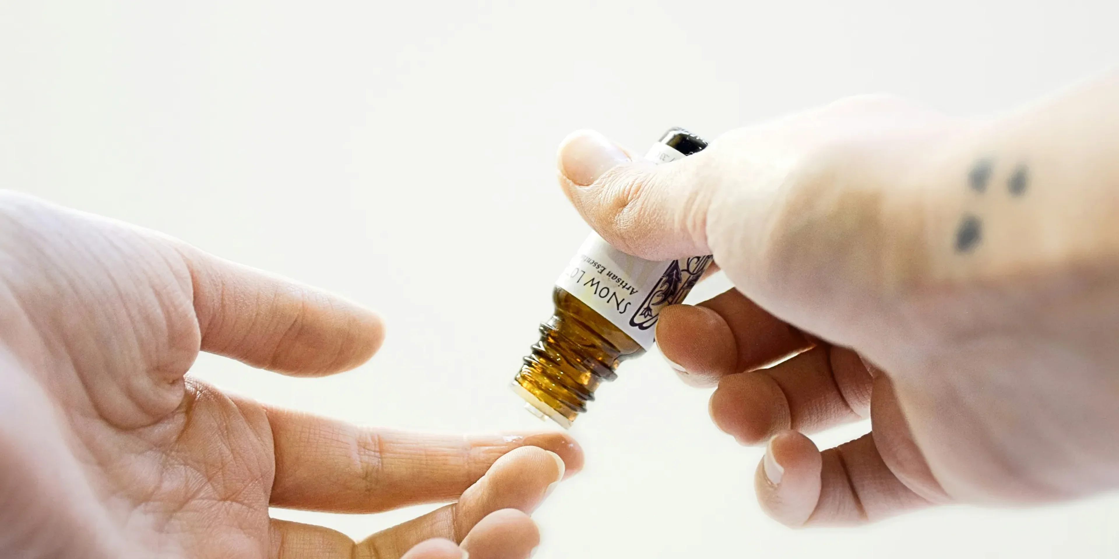 person holding brown glass bottle