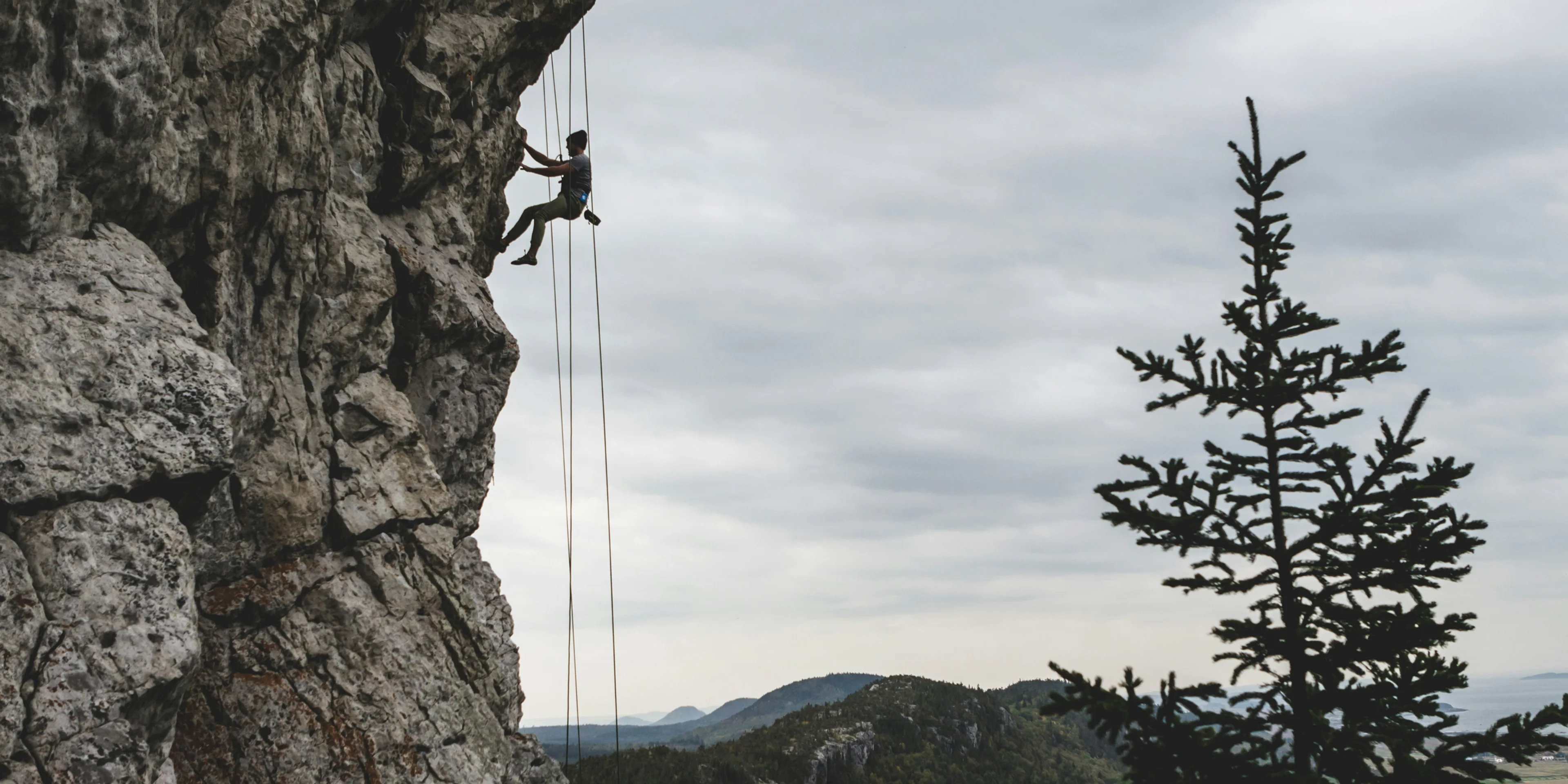 man rock climbing.