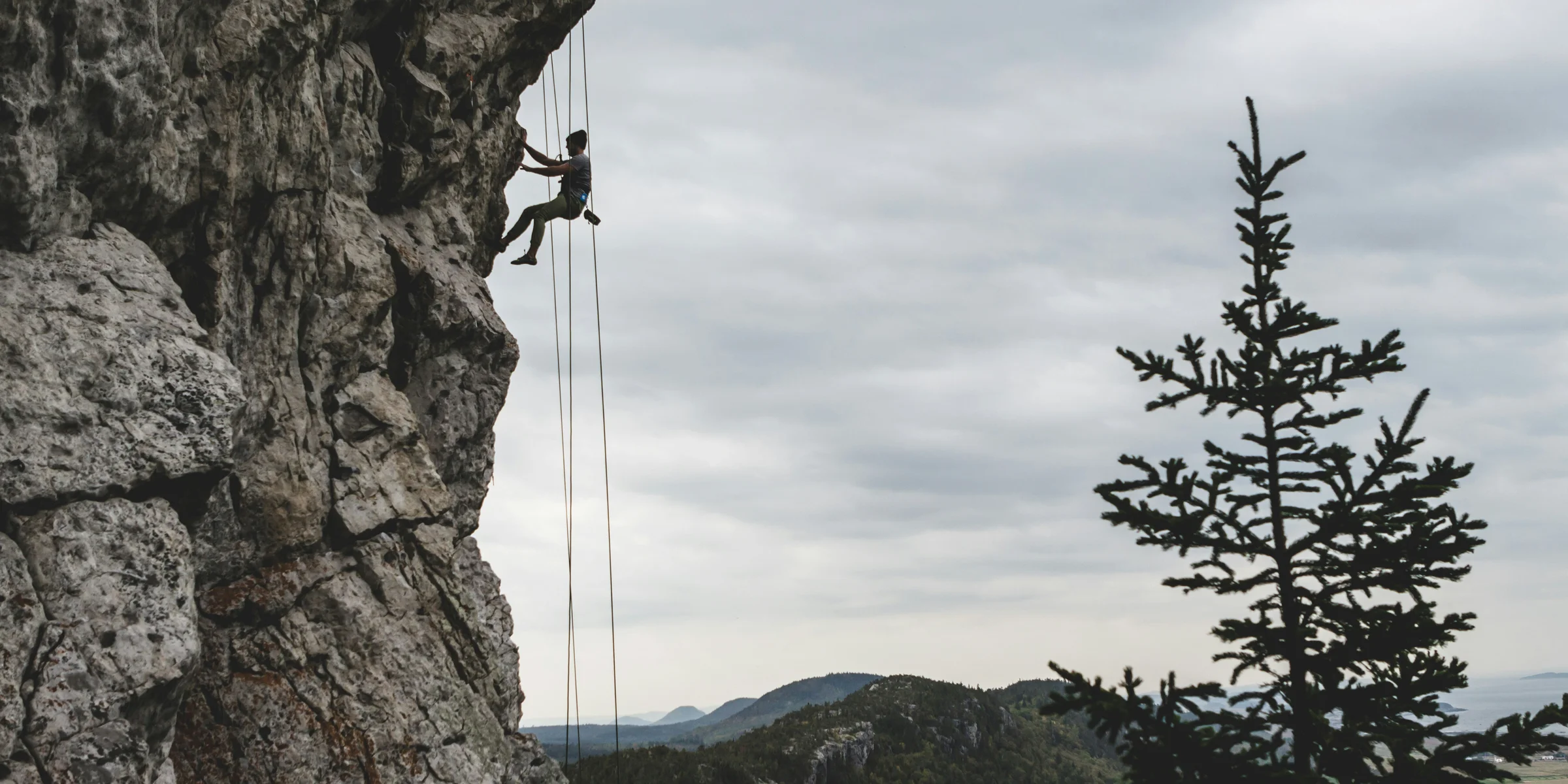 man rock climbing.