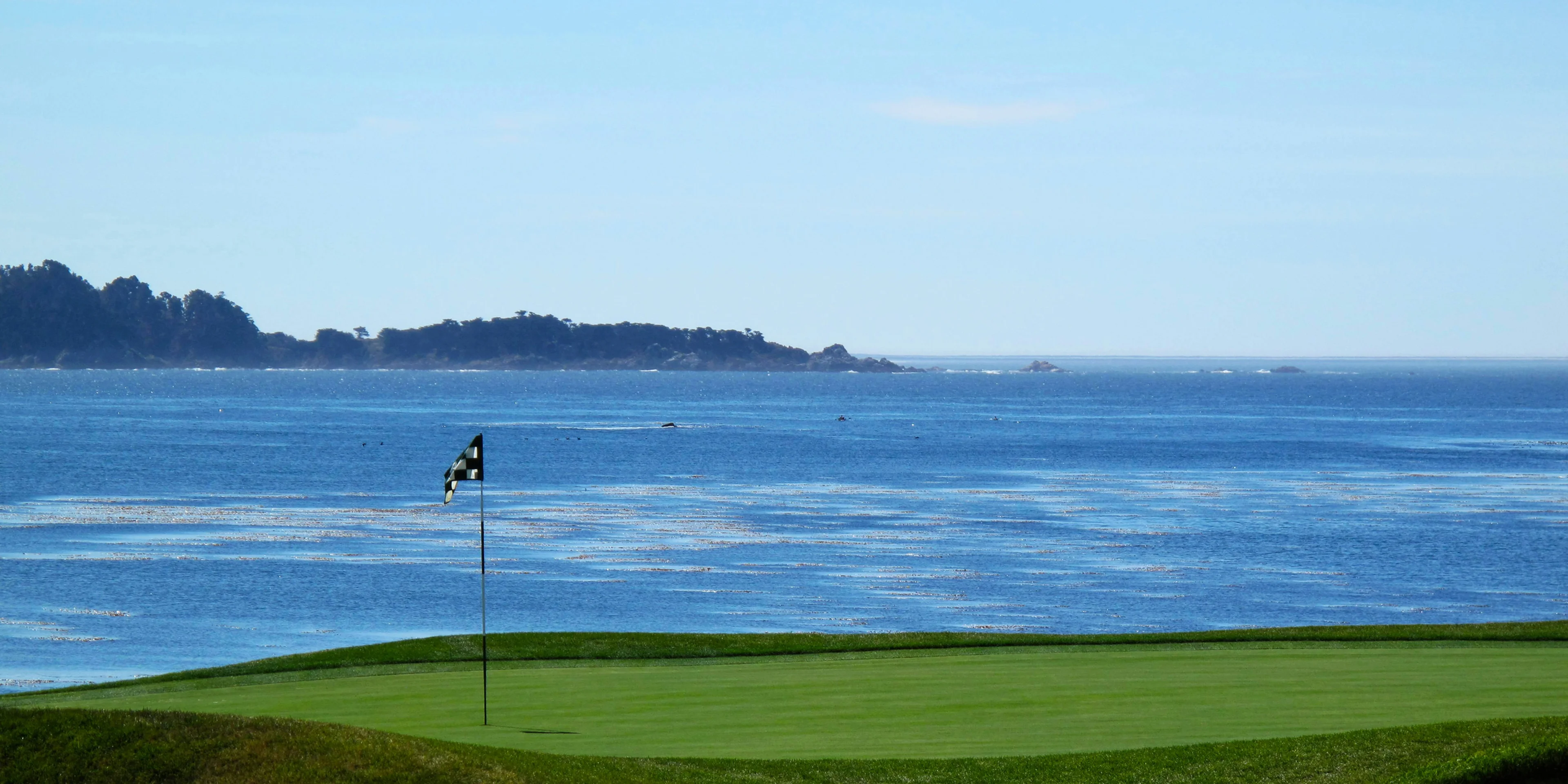 golf course near body of water.