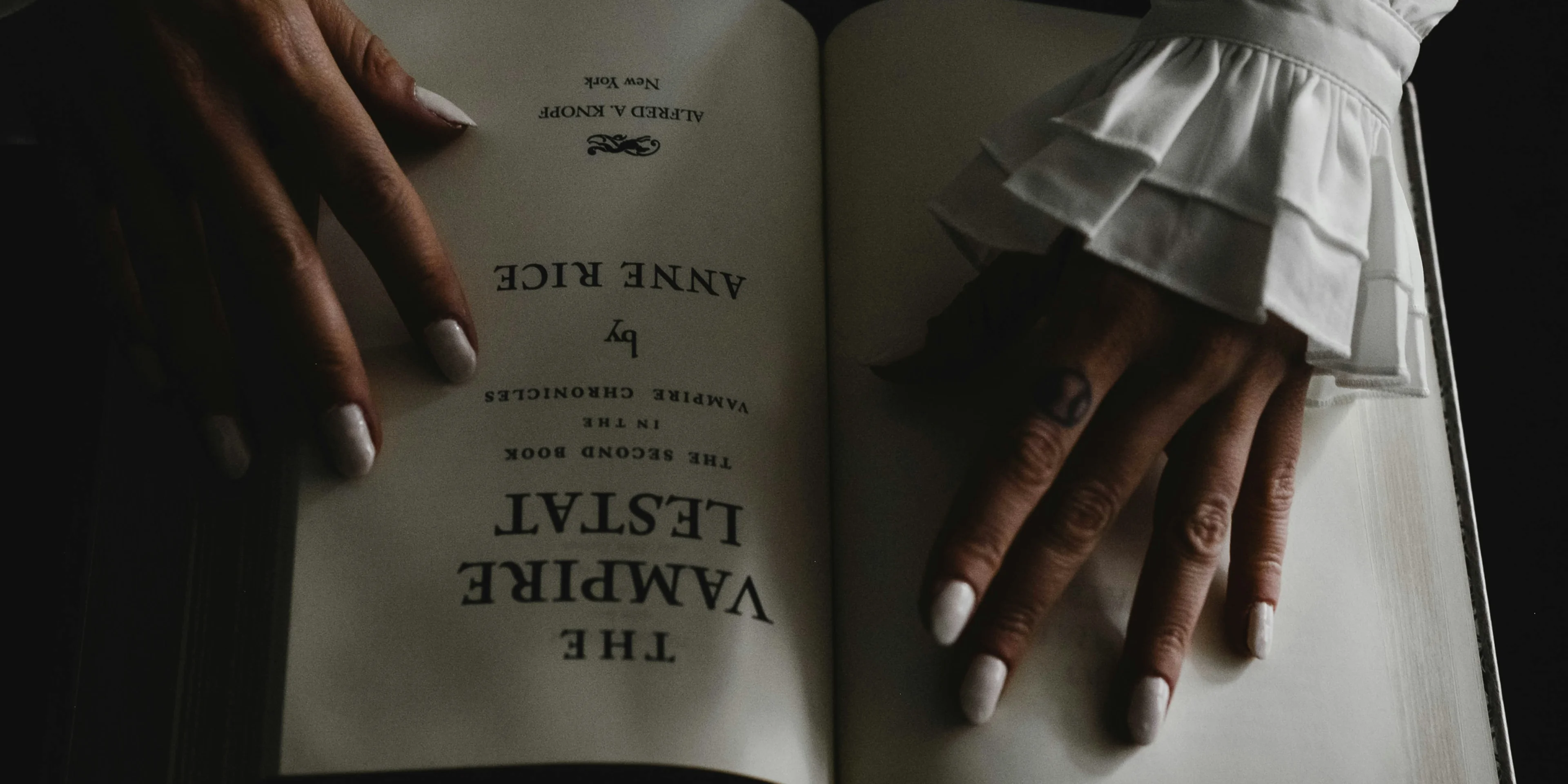 a woman's hands holding an open book.