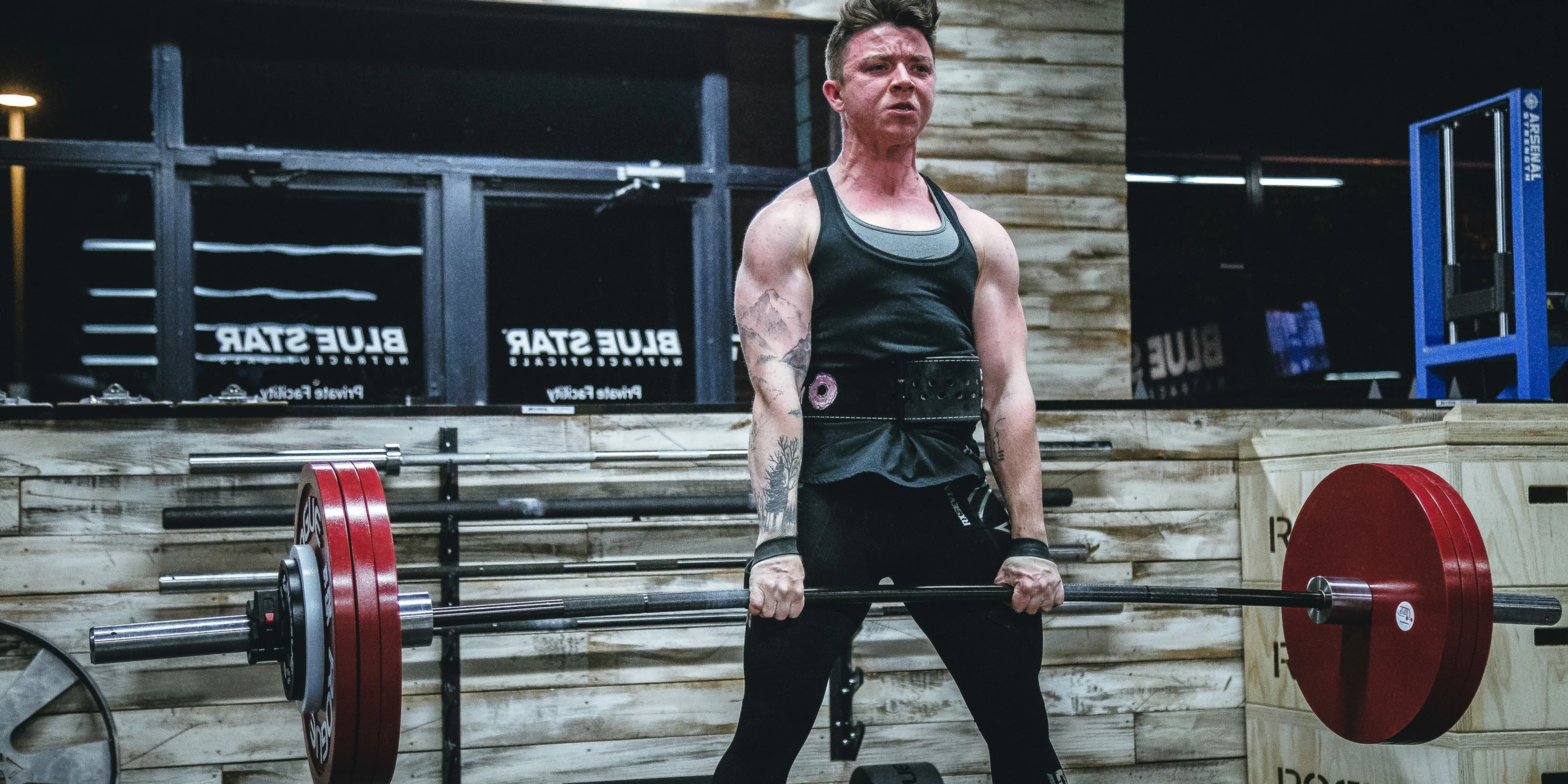 man lifting barbell