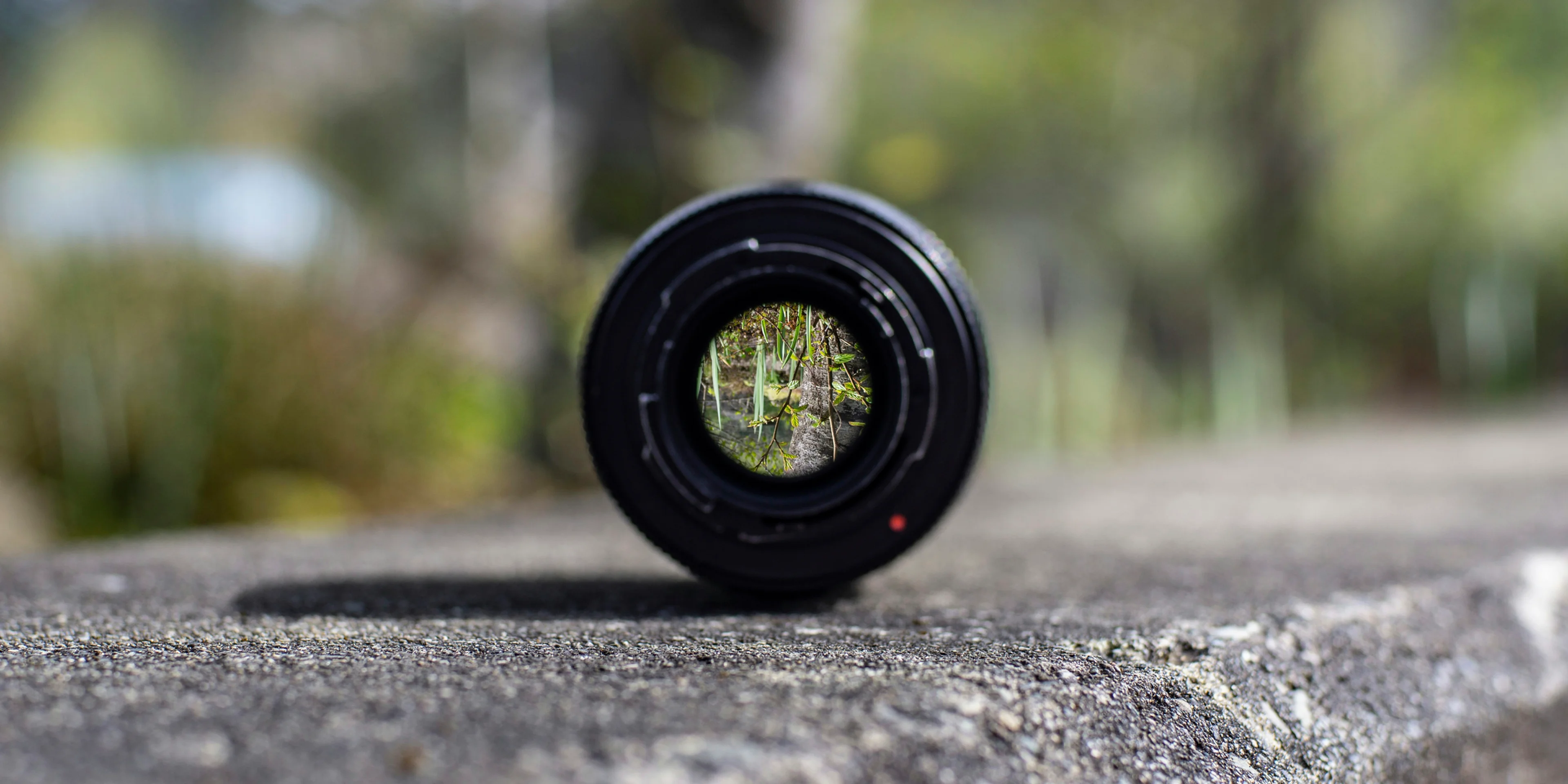 black DSLR camera lens on concrete surface.