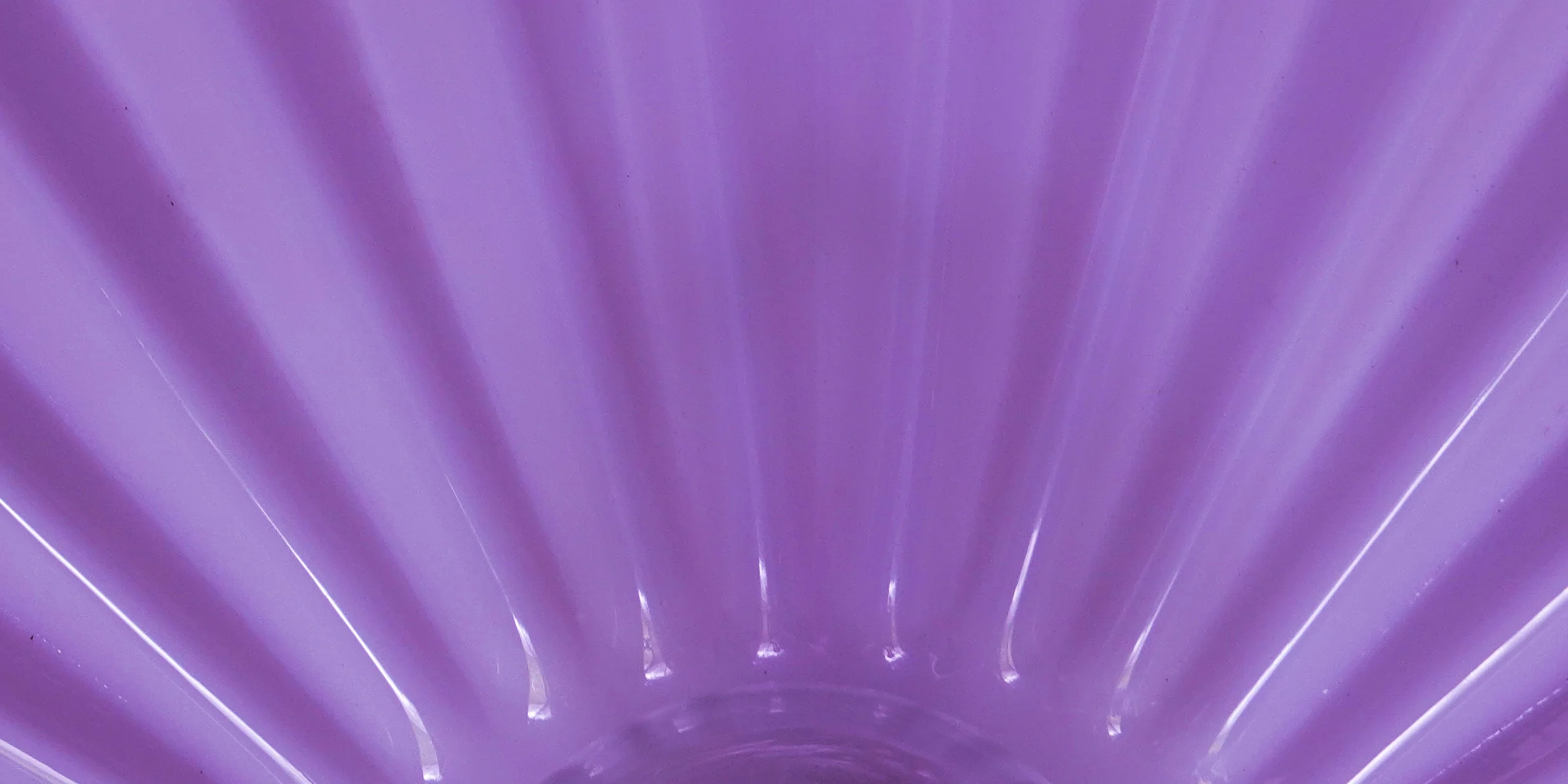 purple plastic container on brown wooden table.