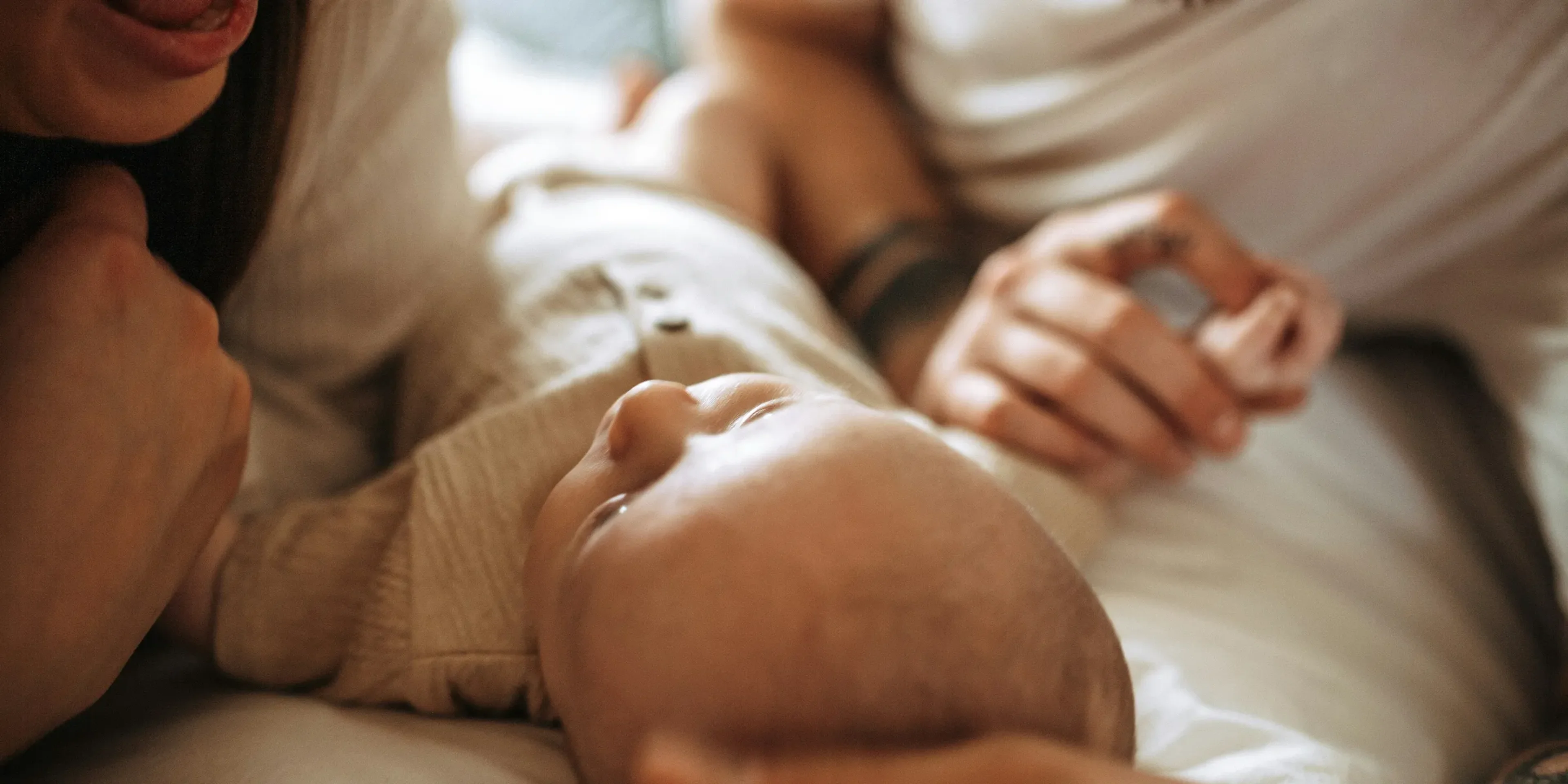 a man and woman holding a baby in their arms