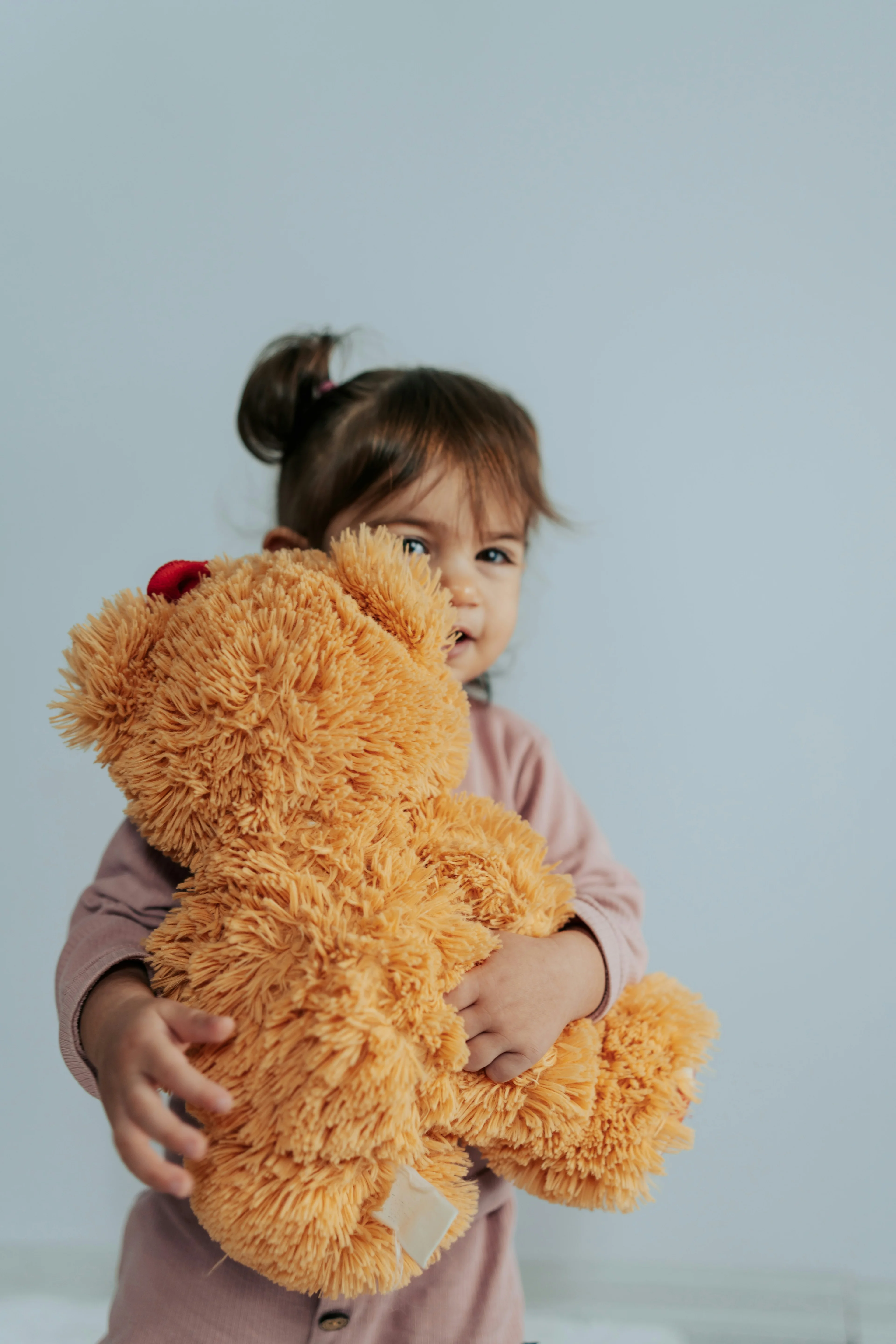 child with stuffed bear