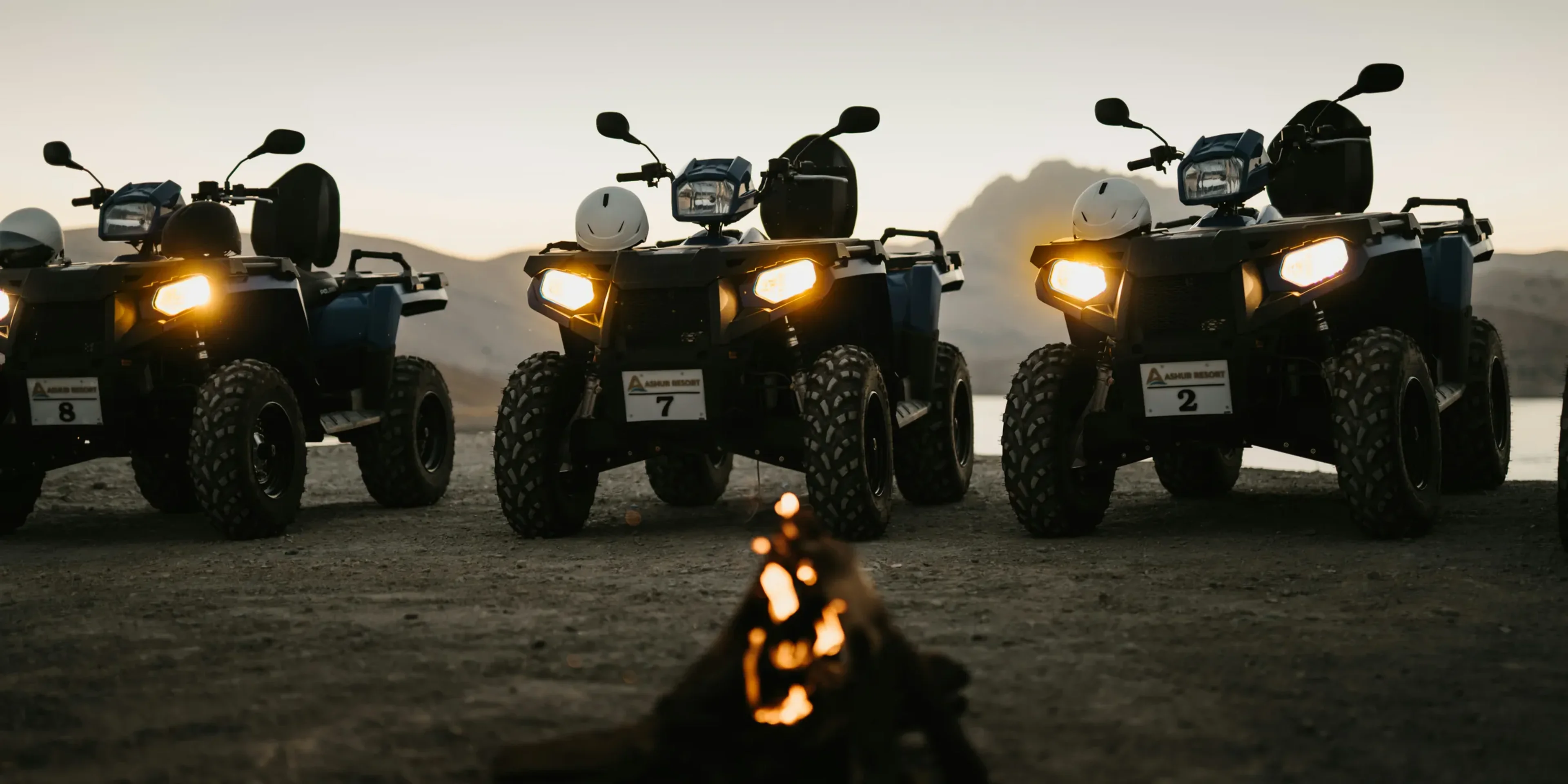 silhouette of 2 people riding atv during sunset