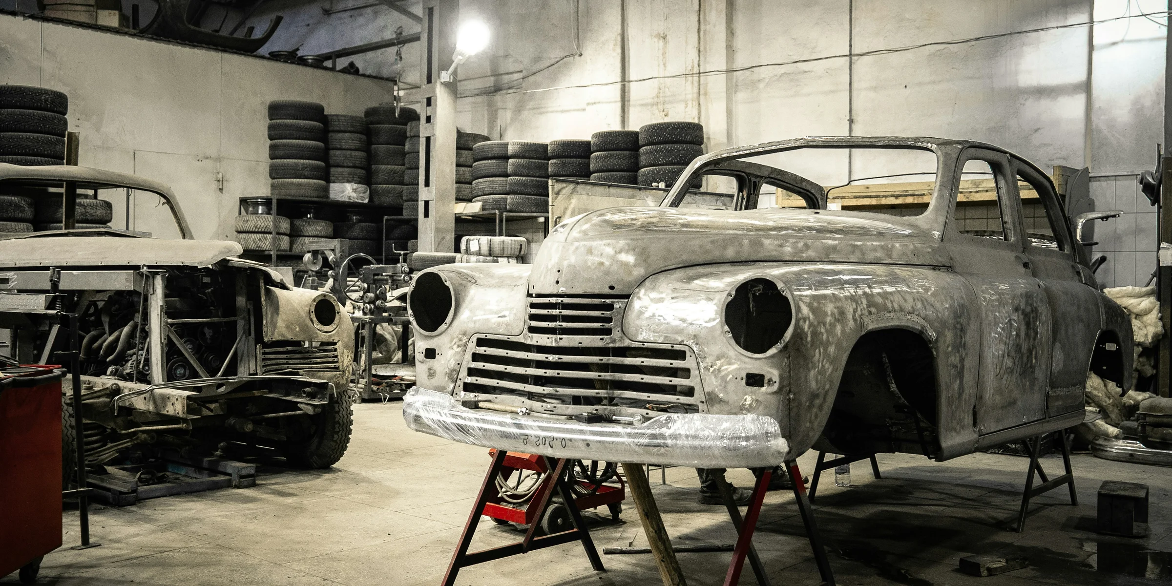 white vintage car in garage.